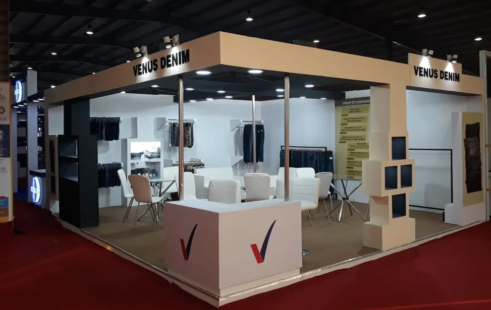 Denim Manufacturer Exhibition Stall Design at Vibrant Gujarat 2019 Gandhinagar — 33 sqm 2 side open trade show booth for Venus Denims at Vibrant Gujarat 2019, 2019