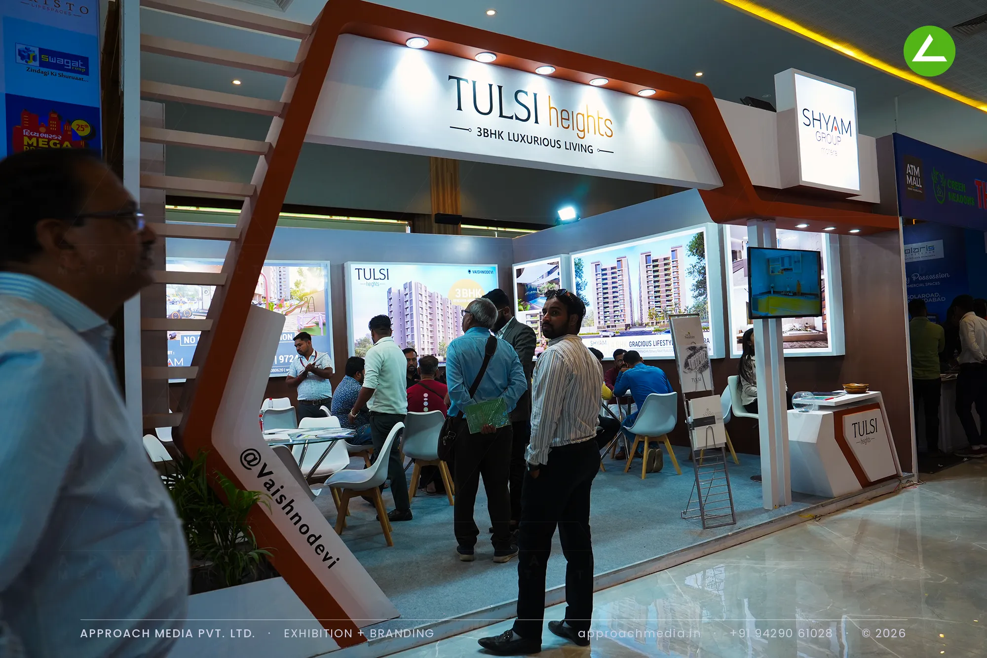 Tulsi Heights exhibition stall design at Divya Bhaskar Property Show Ahmedabad with an angled white portal