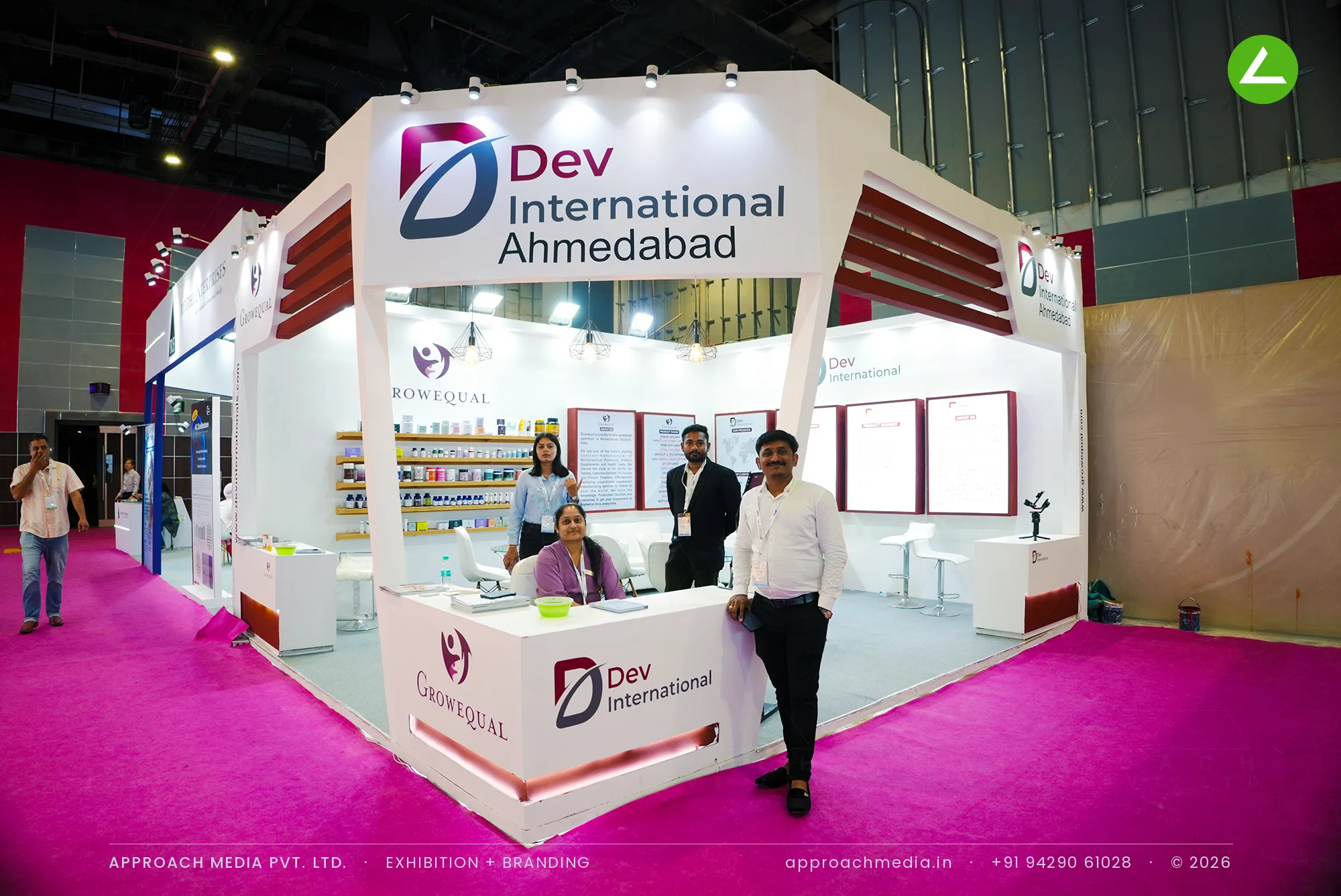 Dev International exhibition stall design at CosmoHome New Delhi with angled white portal and timber product shelves