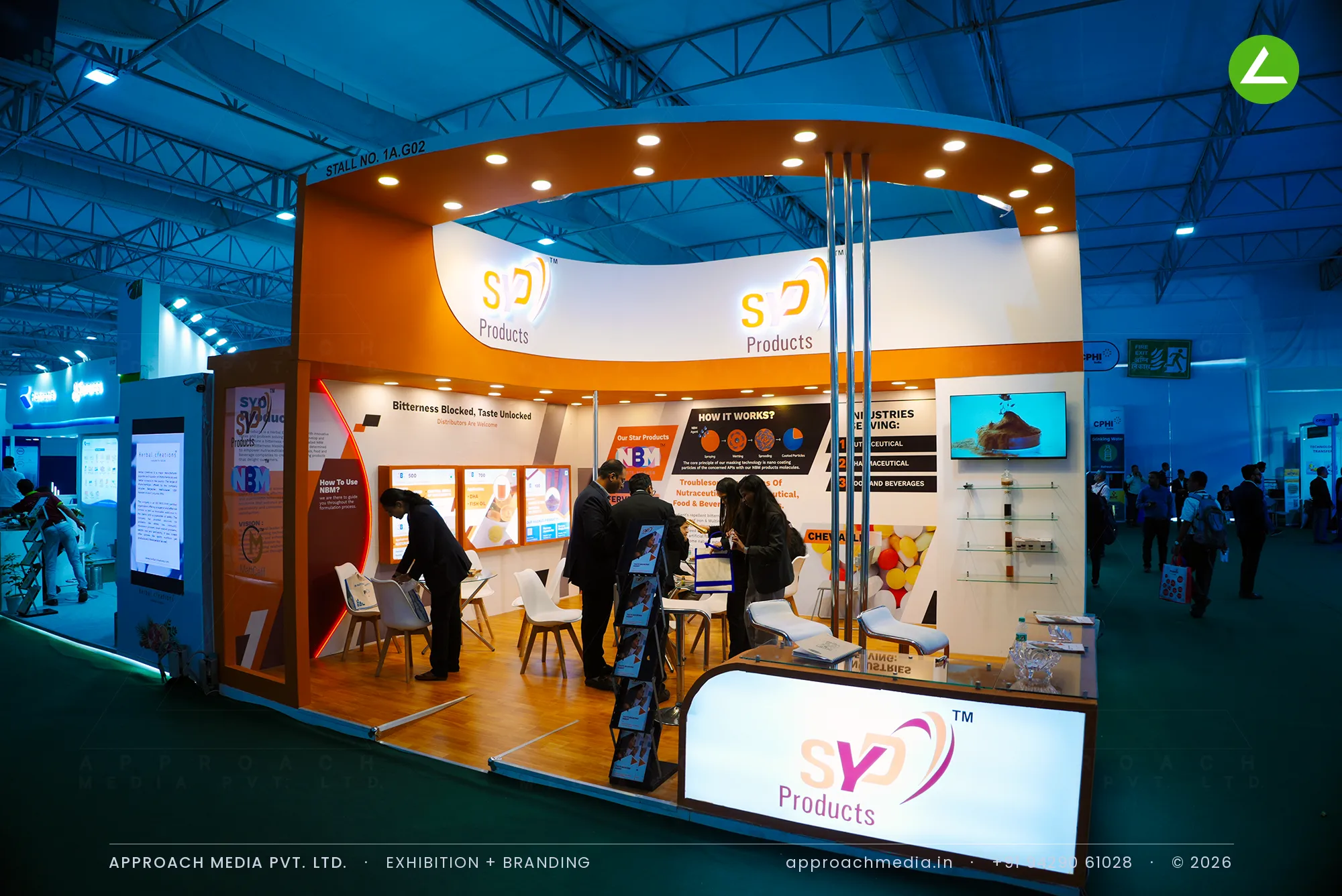 SYD Products exhibition stall design at CPHI Greater Noida with curved orange canopy and backlit counter