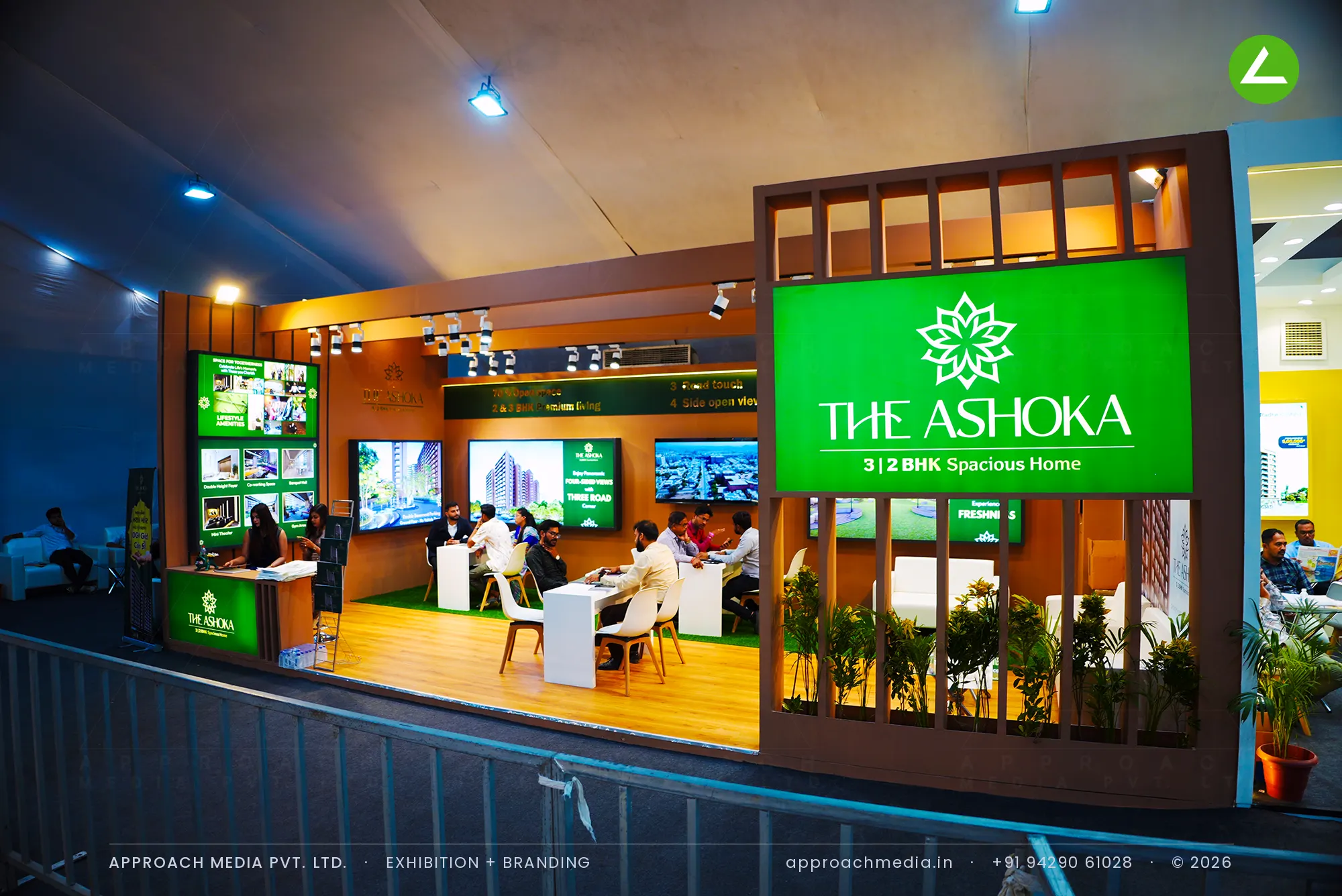 The Ashoka exhibition stall design at Divya Bhaskar Property Show Vastral Ahmedabad with timber battens and green lightbox