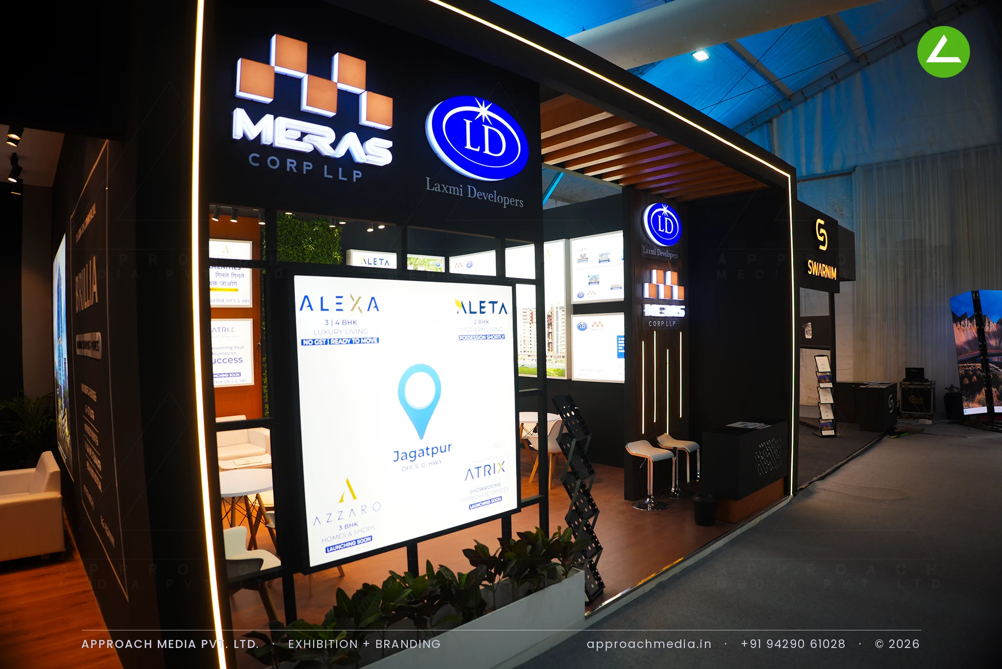 Laxmi Developers exhibition stall design at NAREDCO Property Expo Ahmedabad with backlit render walls and timber flooring