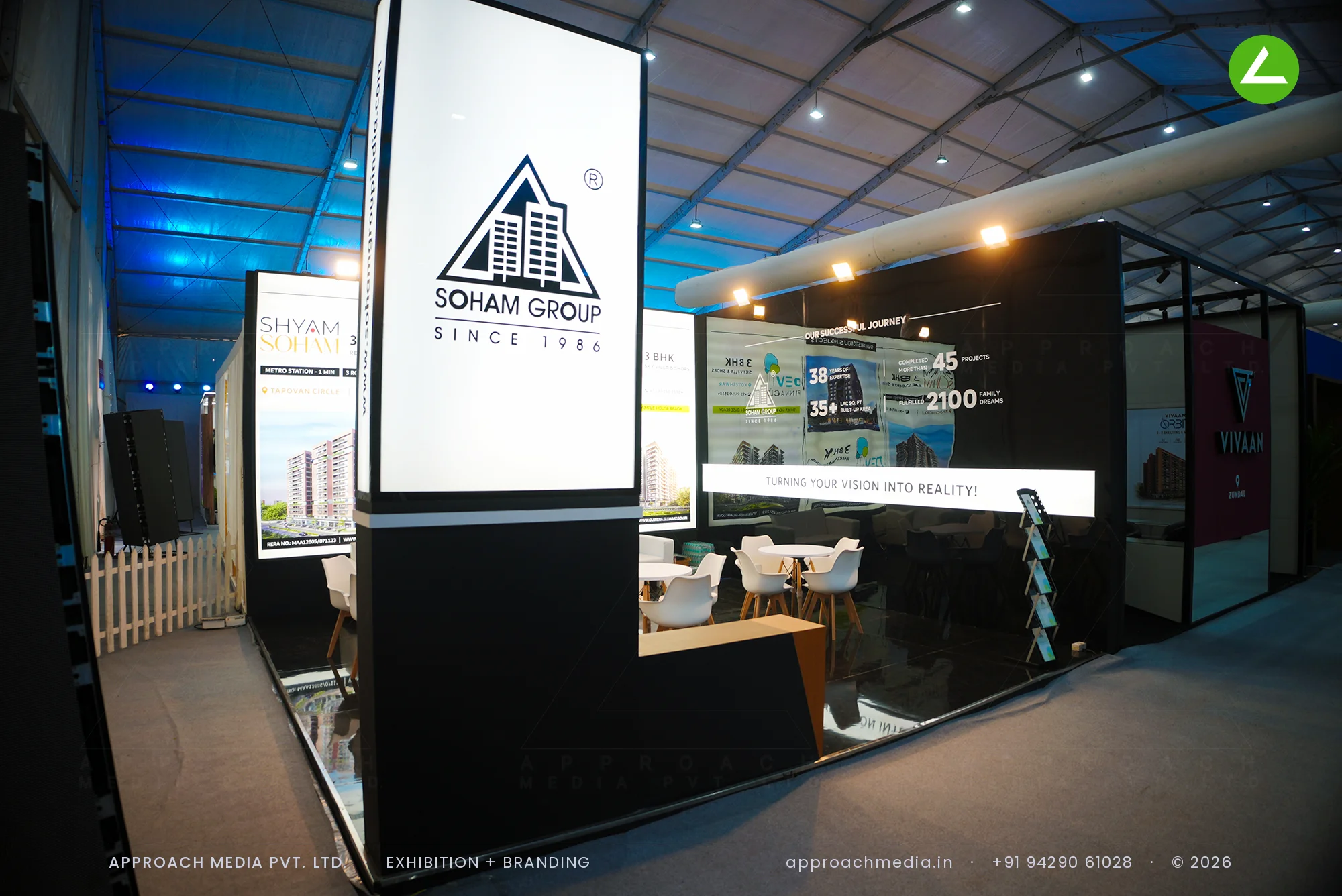 Black exhibition stall design at NAREDCO Property Expo Ahmedabad for Soham Group with a lit corner logo tower