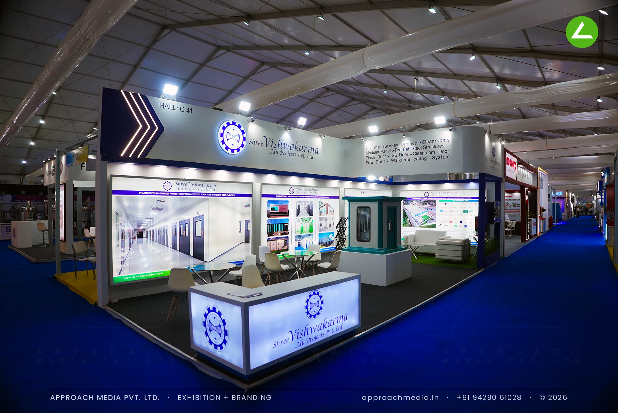 Shree Vishwakarma exhibition stall design at Pharmatech Expo Chandigarh with a lit counter and navy-framed graphic wall