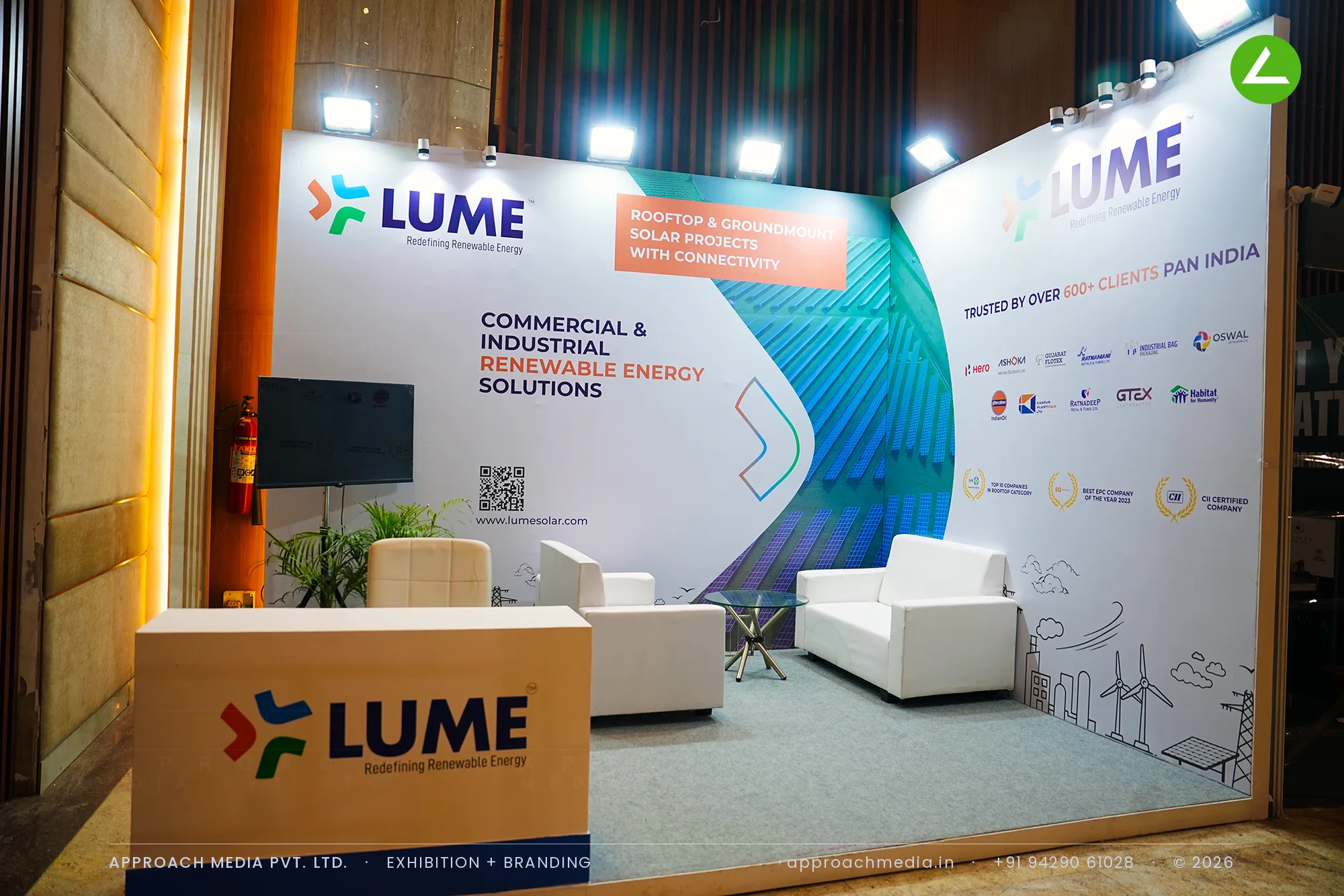 Printed teal brand wall and sofa lounge at the LUME exhibition stall design at Vyapar Bazaar Ahmedabad