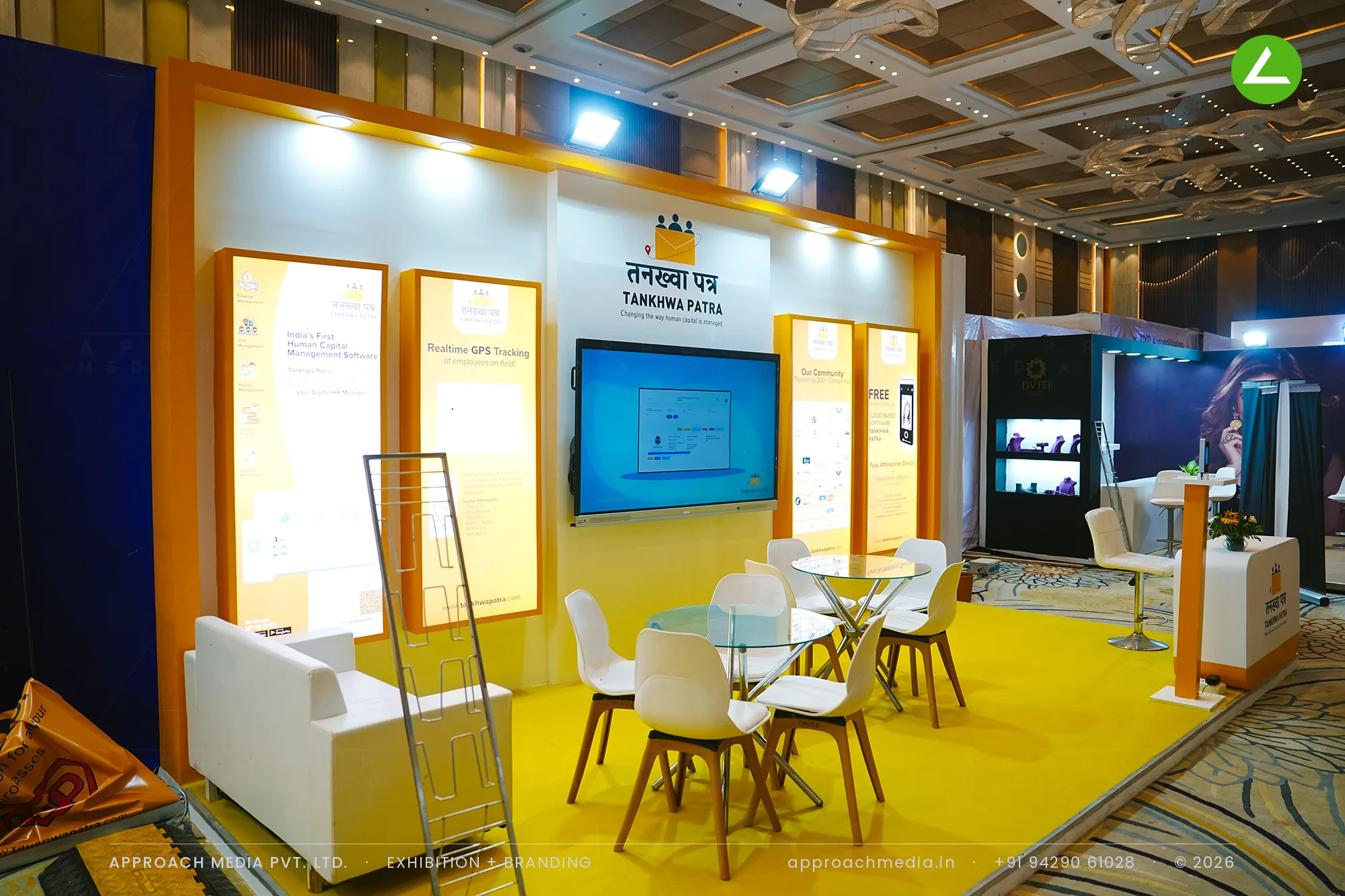 Tankhwa Patra exhibition stall design at Vyapar Bazaar Ahmedabad with backlit orange panels and a central demo screen