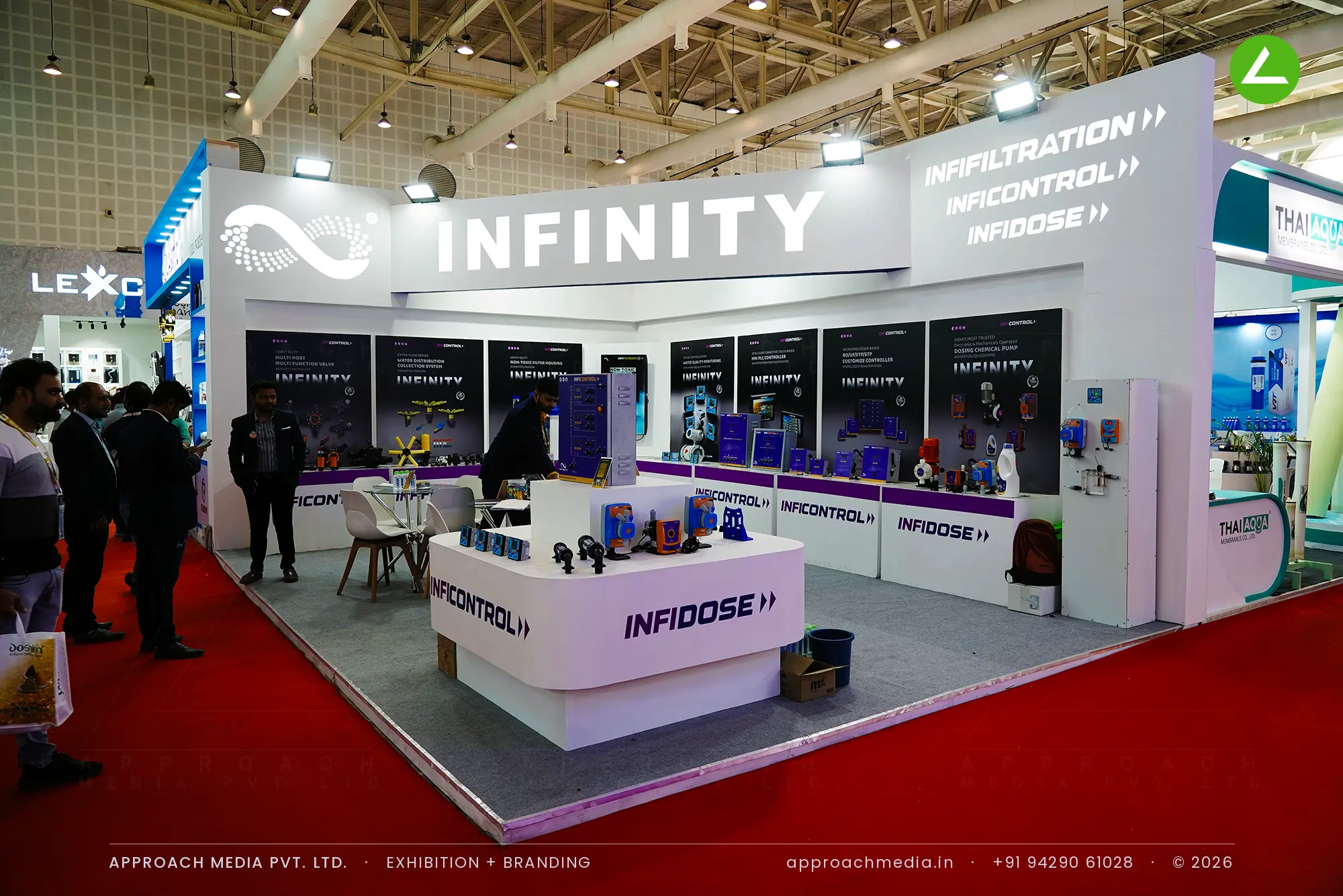 Infinity exhibition stall design at WAPTAG Water Expo Gandhinagar with a raked white fascia and violet-banded counters