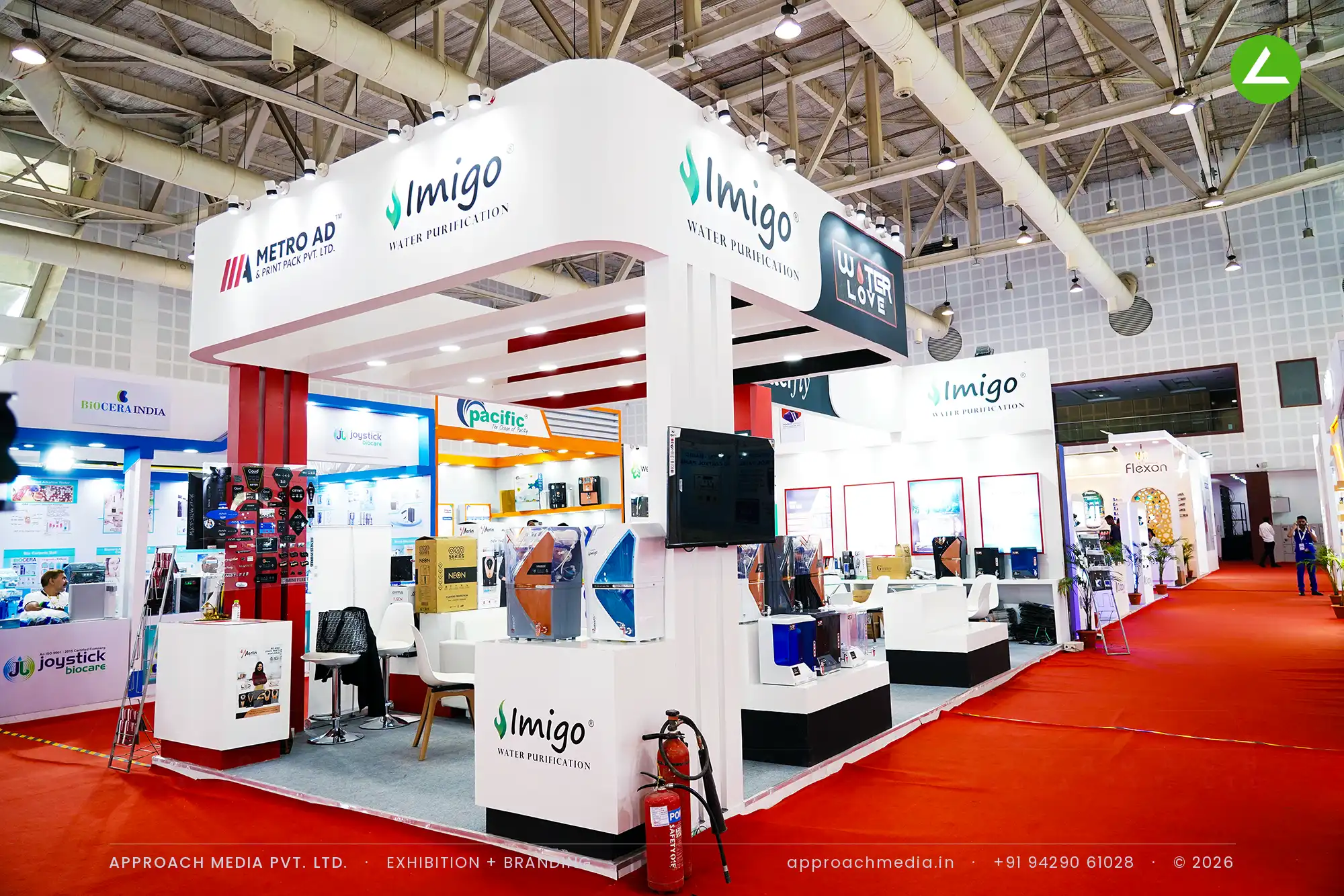Metro Ad and Print Pack exhibition stall design at WAPTAG Water Expo Gandhinagar with a white canopy and red fluted column