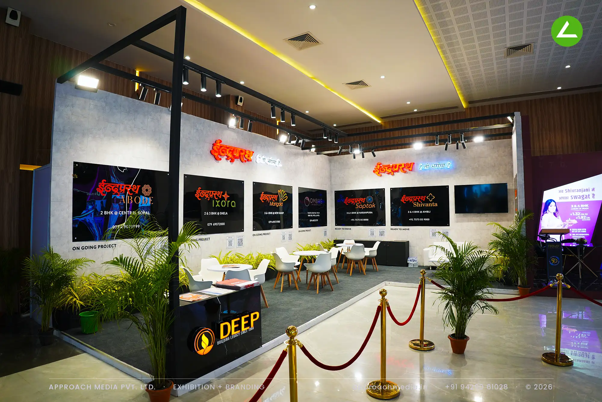 Seven neon-lit project panels on Deep Indraprasth's grey cement-textured wall, under an orange and blue neon brand line