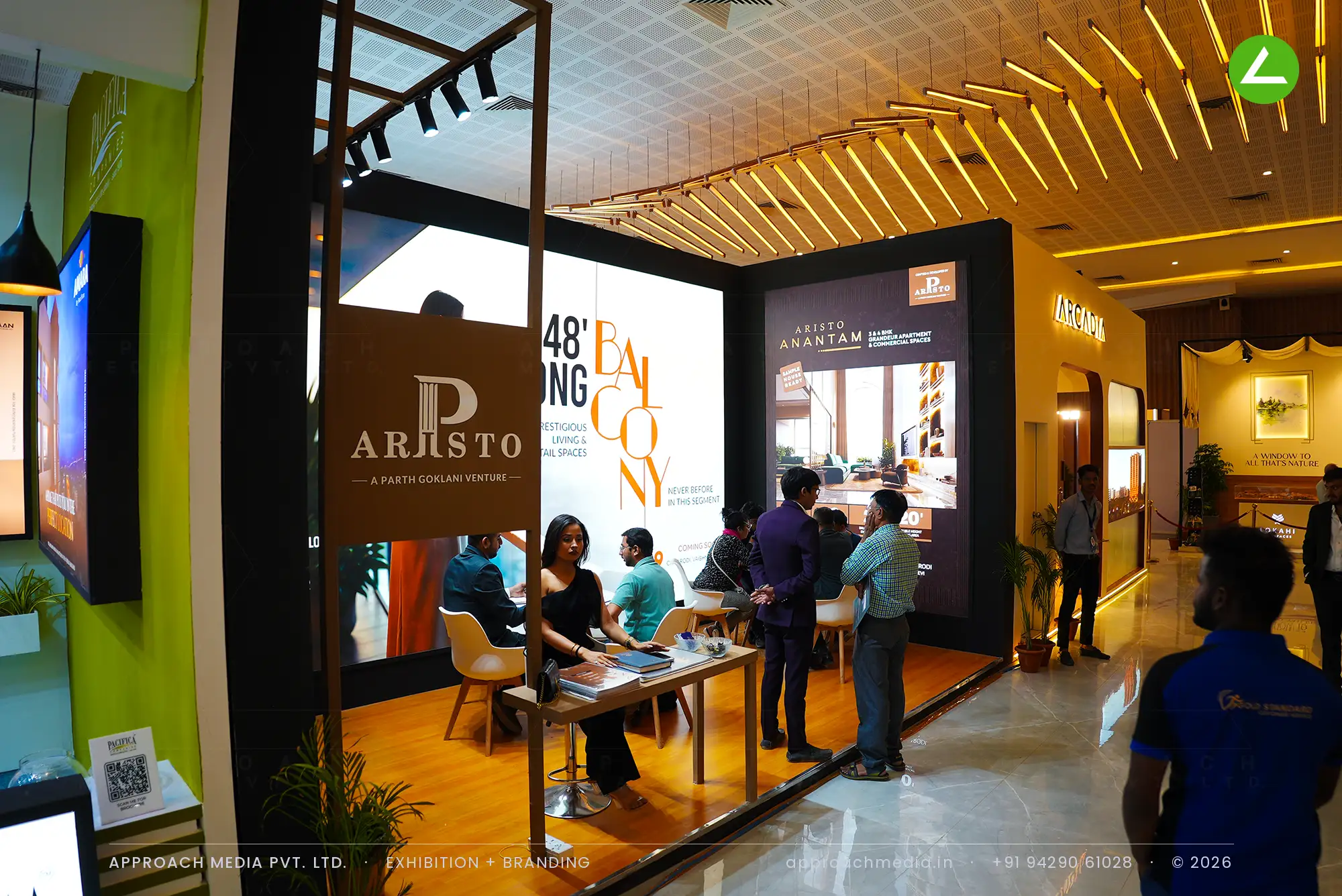 Aristo's coffee-brown and gold graphic bay on raised honey-wood decking, under a black pergola frame with track spots