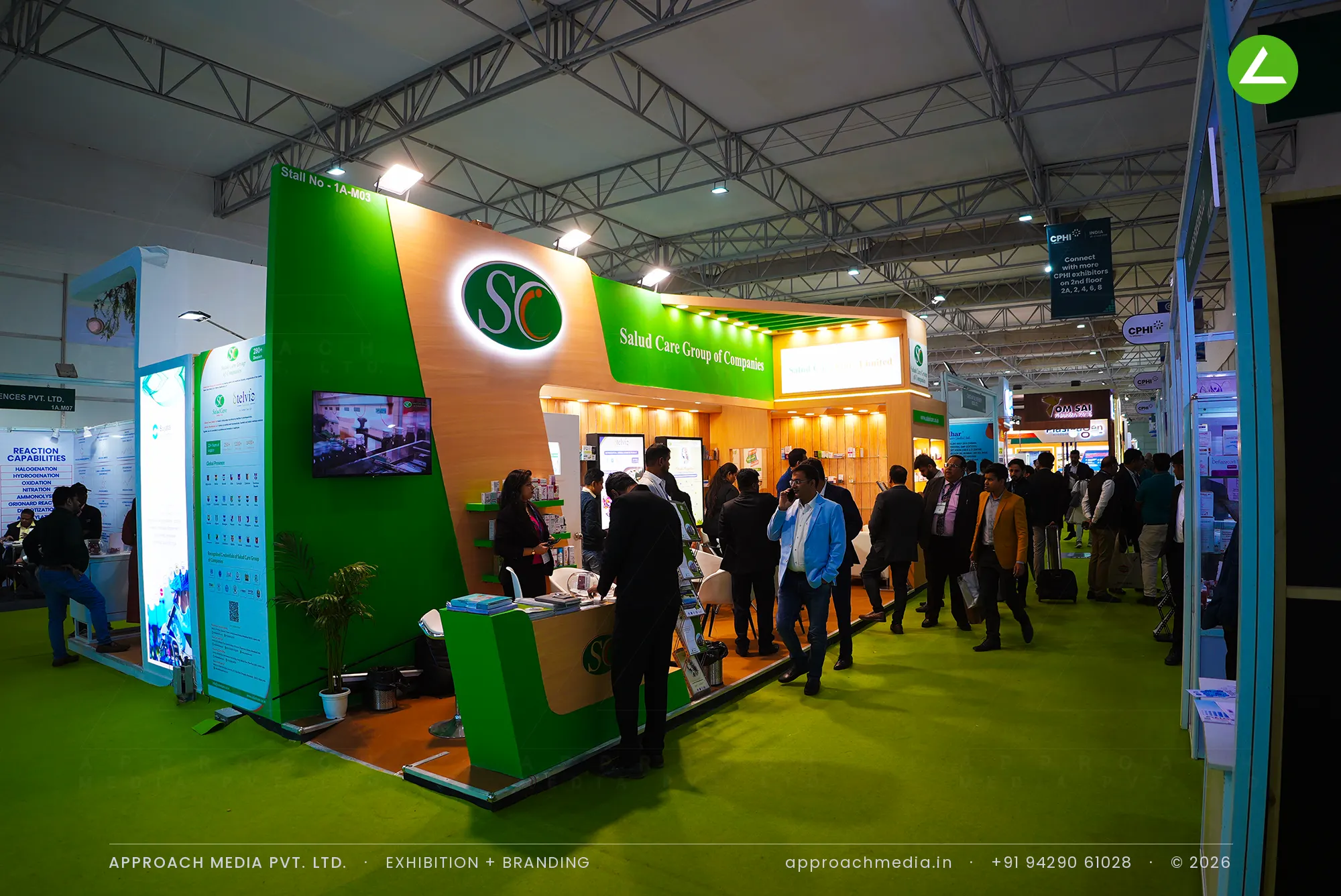 Salud Care exhibition stall design at CPHI Greater Noida with an angled green fascia and illuminated SC monogram