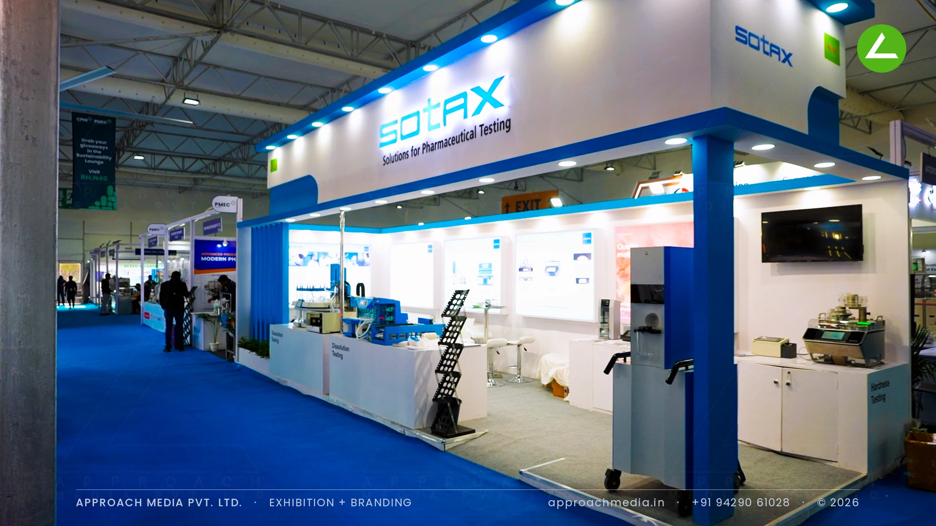 SOTAX exhibition stall design at CPHI Greater Noida with a blue-edged lit soffit over labelled instrument plinths