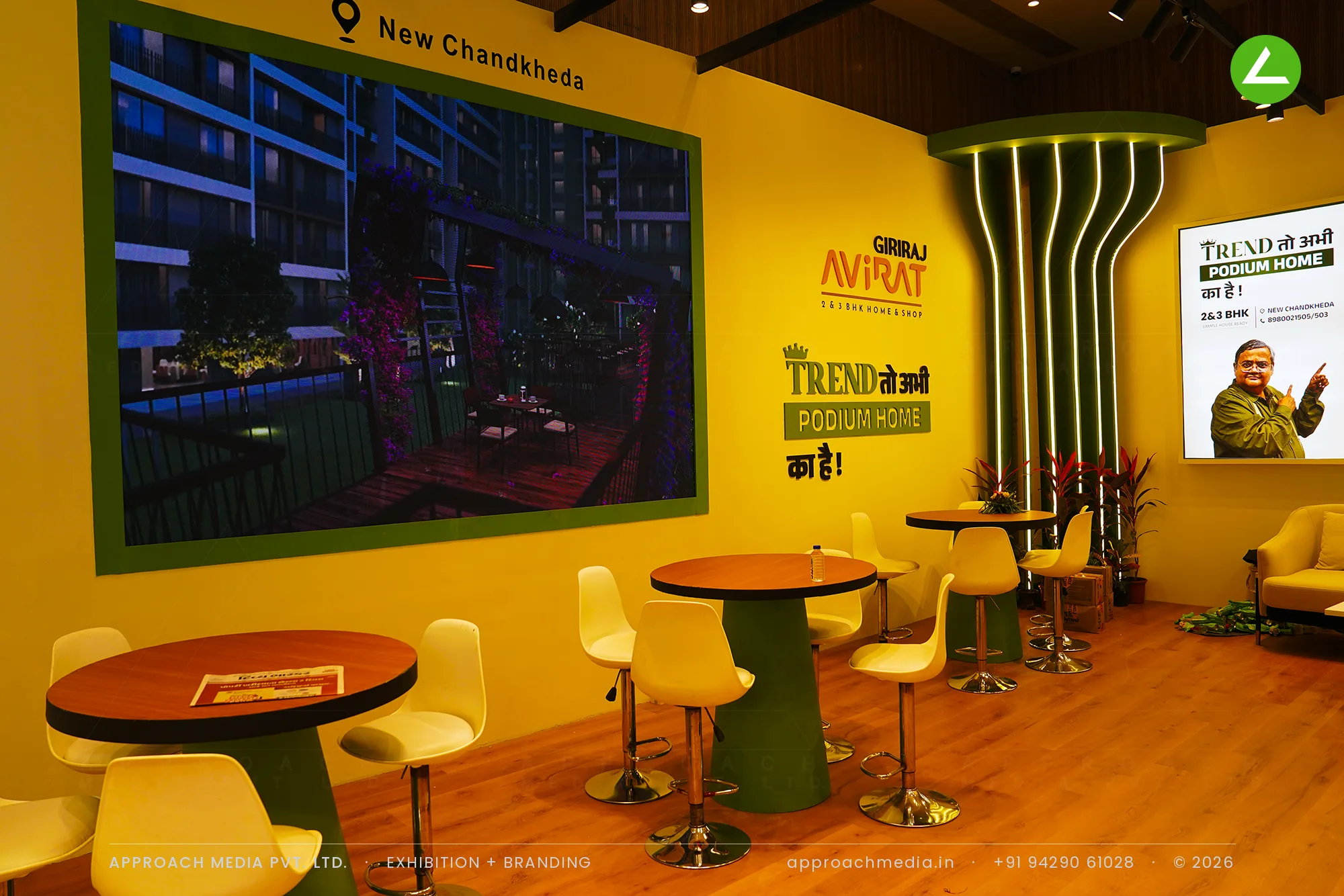 Giriraj Avirat at Divya Bhaskar Property Expo Ahmedabad — a yellow-and-green exhibition stall design — photo 4