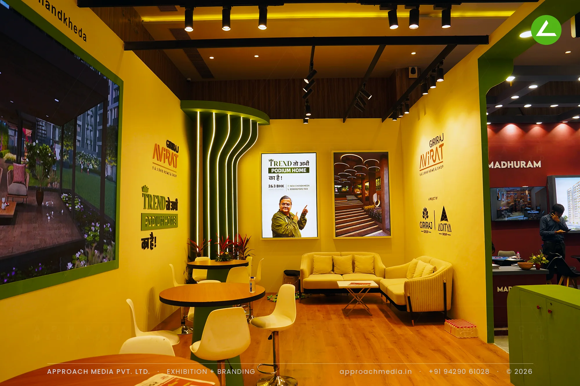 Giriraj Avirat at Divya Bhaskar Property Expo Ahmedabad — a yellow-and-green exhibition stall design — photo 3