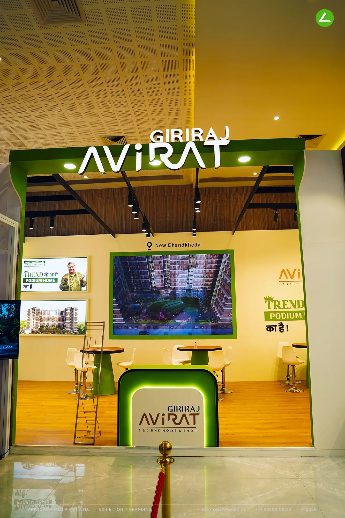 Giriraj Avirat at Divya Bhaskar Property Expo Ahmedabad — a yellow-and-green exhibition stall design — photo 2