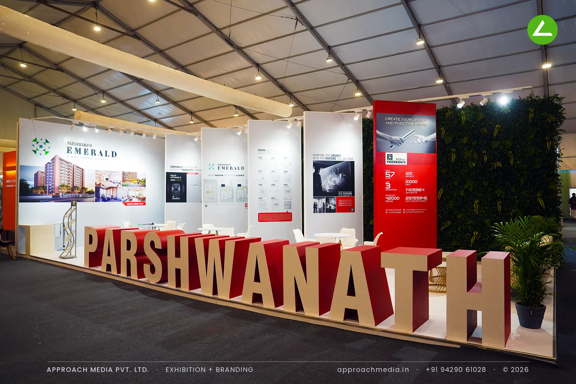 Parshwanath's stall at the GIHED Property Show Ahmedabad, with giant red letters running along the raised front edge