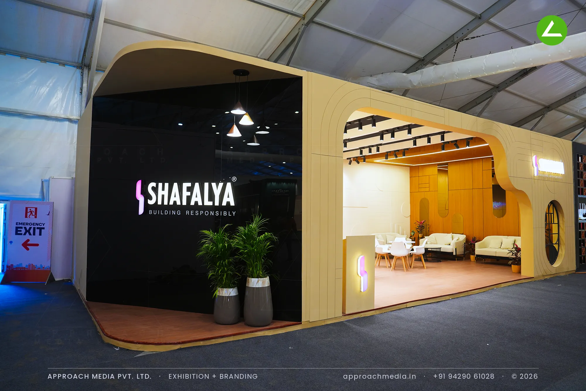 Shafalya's sand-toned stall at the GIHED Property Show Ahmedabad, with arched openings and a lit black gloss sign