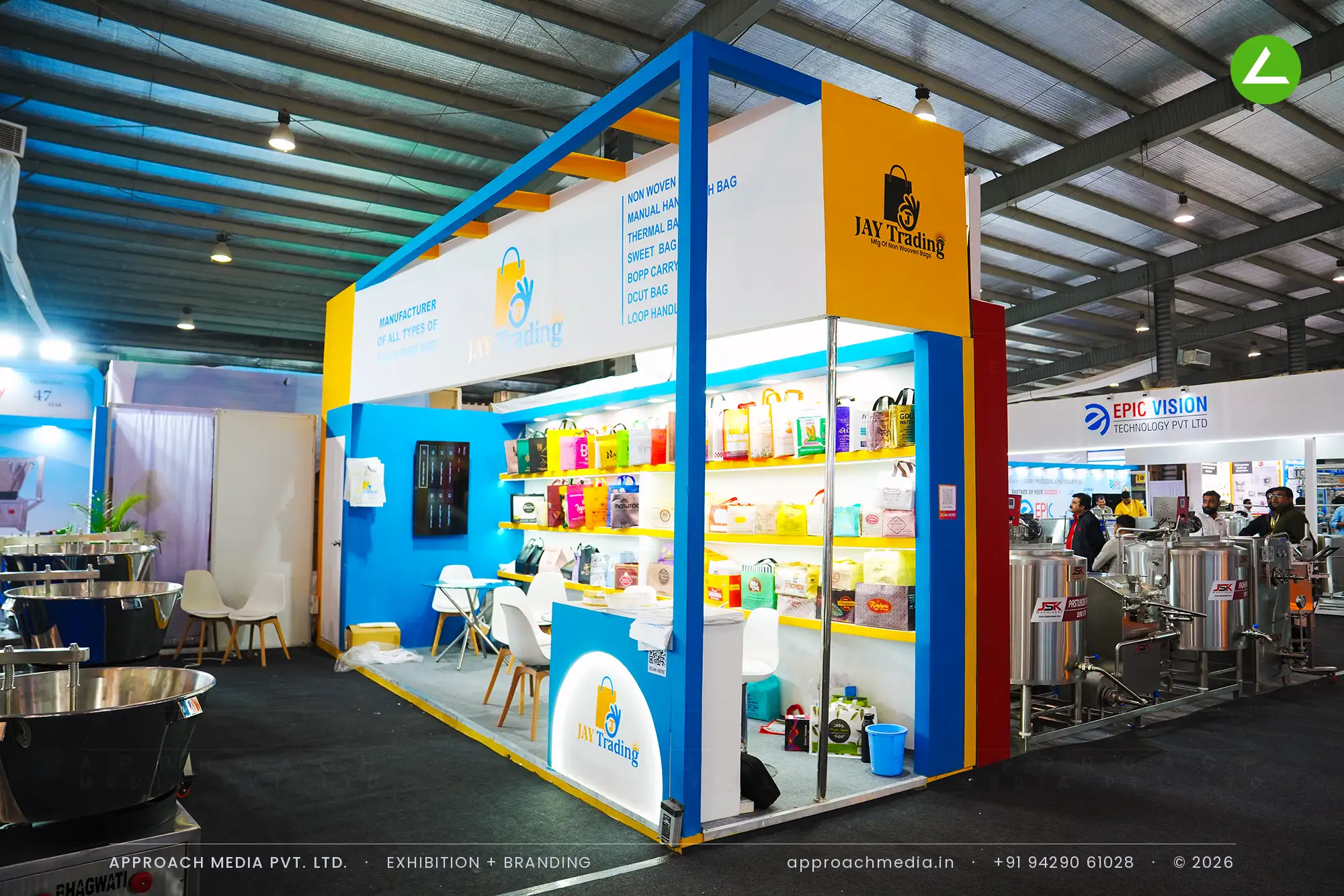 Jay Trading exhibition stall design at Khadhya Khorak Expo Gandhinagar with a lit three-tier bag shelf wall