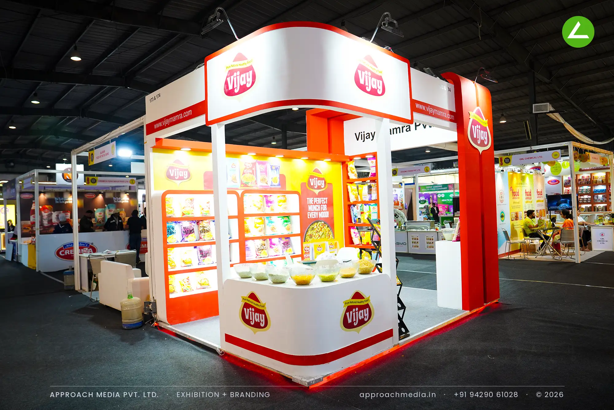 Vijay Mamra 9 sqm exhibition stall design at Khadhya Khorak Expo Gandhinagar with curved red fascia and lit racks