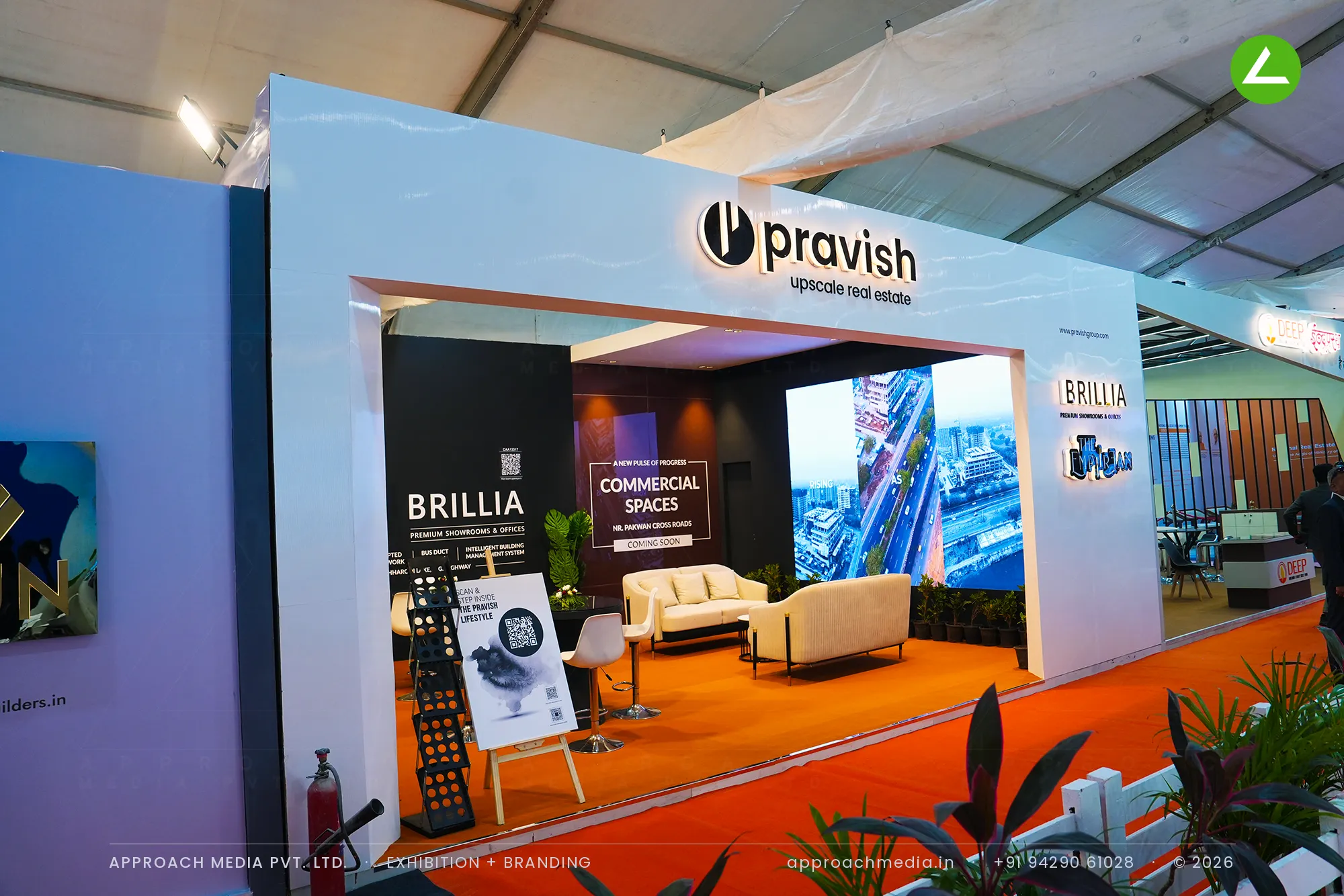 Pravish exhibition stall design at NAREDCO Property Expo Ahmedabad with halo-lit facade and black interior gallery