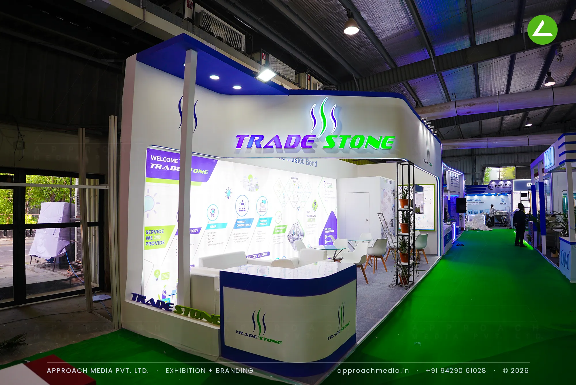 Trade Stone faceted white fascia with lit gradient letters, exhibition stall design at Pharmatech Expo Gandhinagar