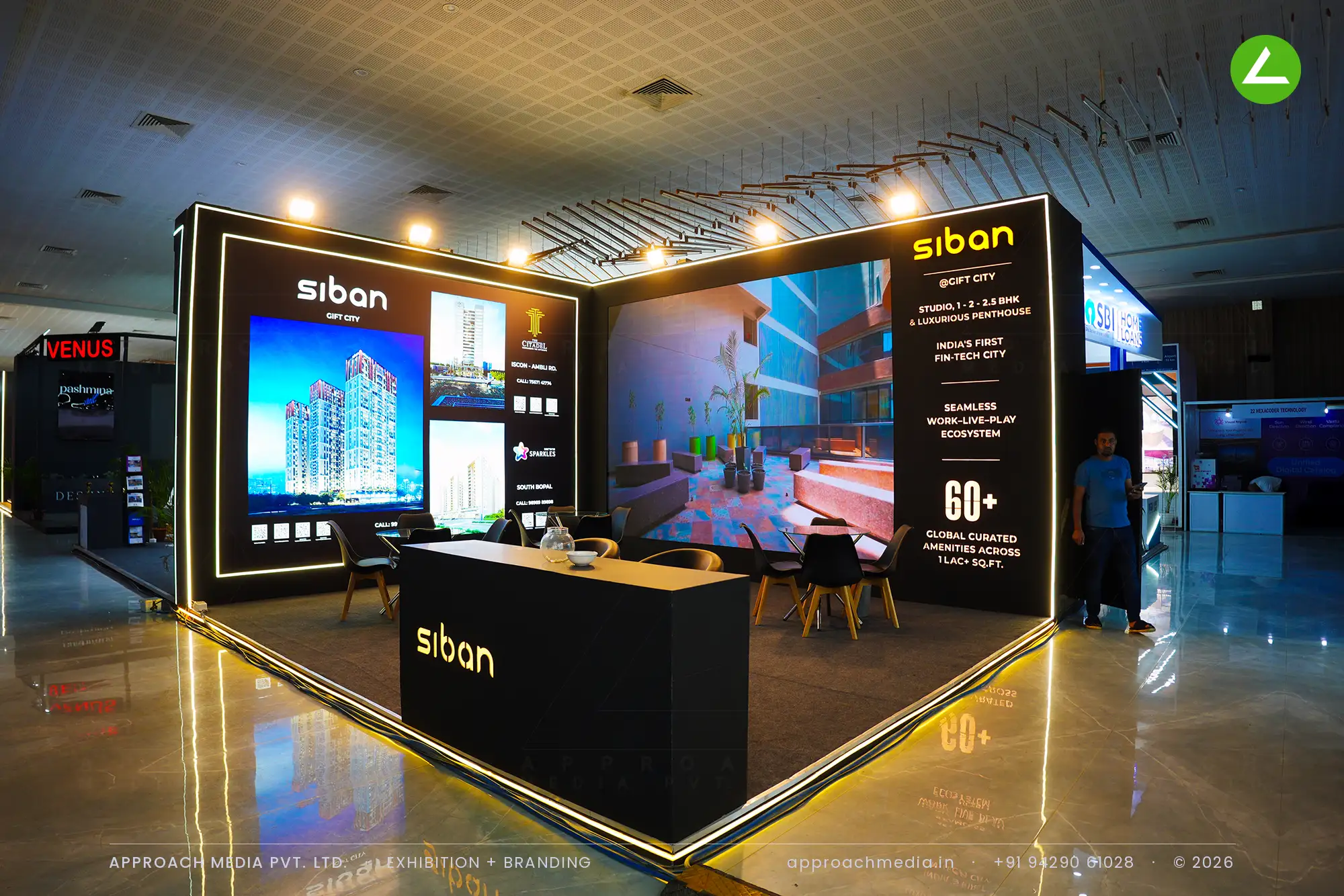 Siban exhibition stall design at Times Property Expo Ahmedabad with gold LED edge lighting and backlit GIFT City renders