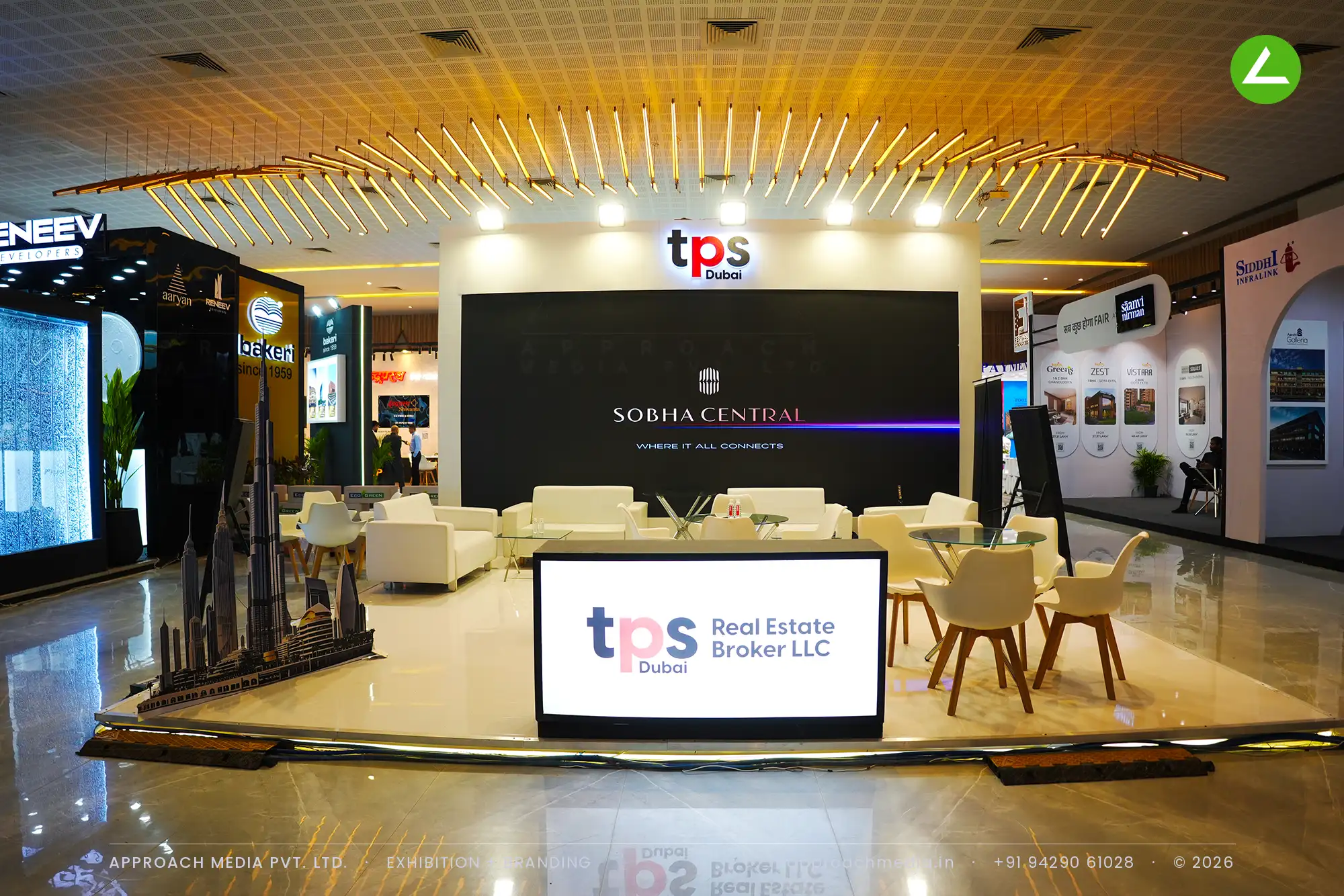 TPS Dubai exhibition stall design at Times Property Expo Ahmedabad with a gold batten ceiling fan and skyline model