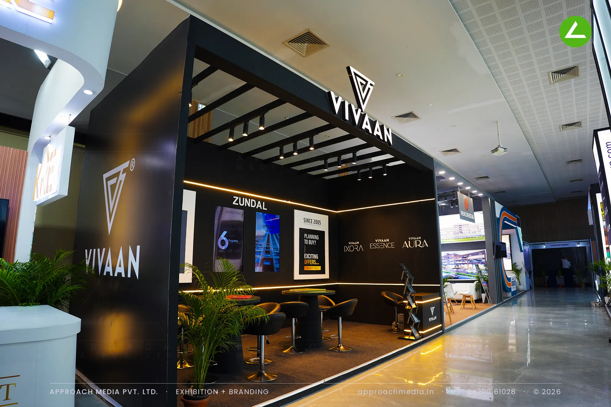 Matte black Vivaan exhibition stall design at Times Property Expo Ahmedabad with pergola ceiling and gold cove lighting