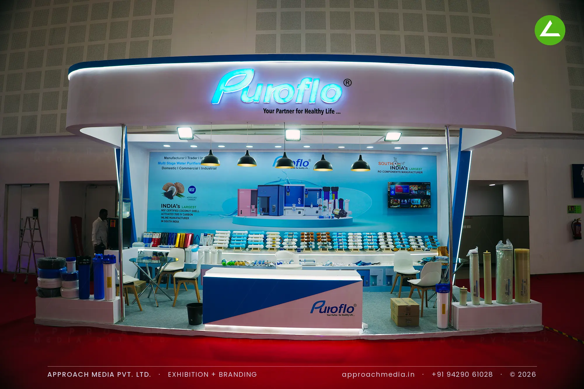 Puroflo exhibition stall design at WAPTAG Water Expo Gandhinagar with a curved backlit arch and blue printed graphic wall