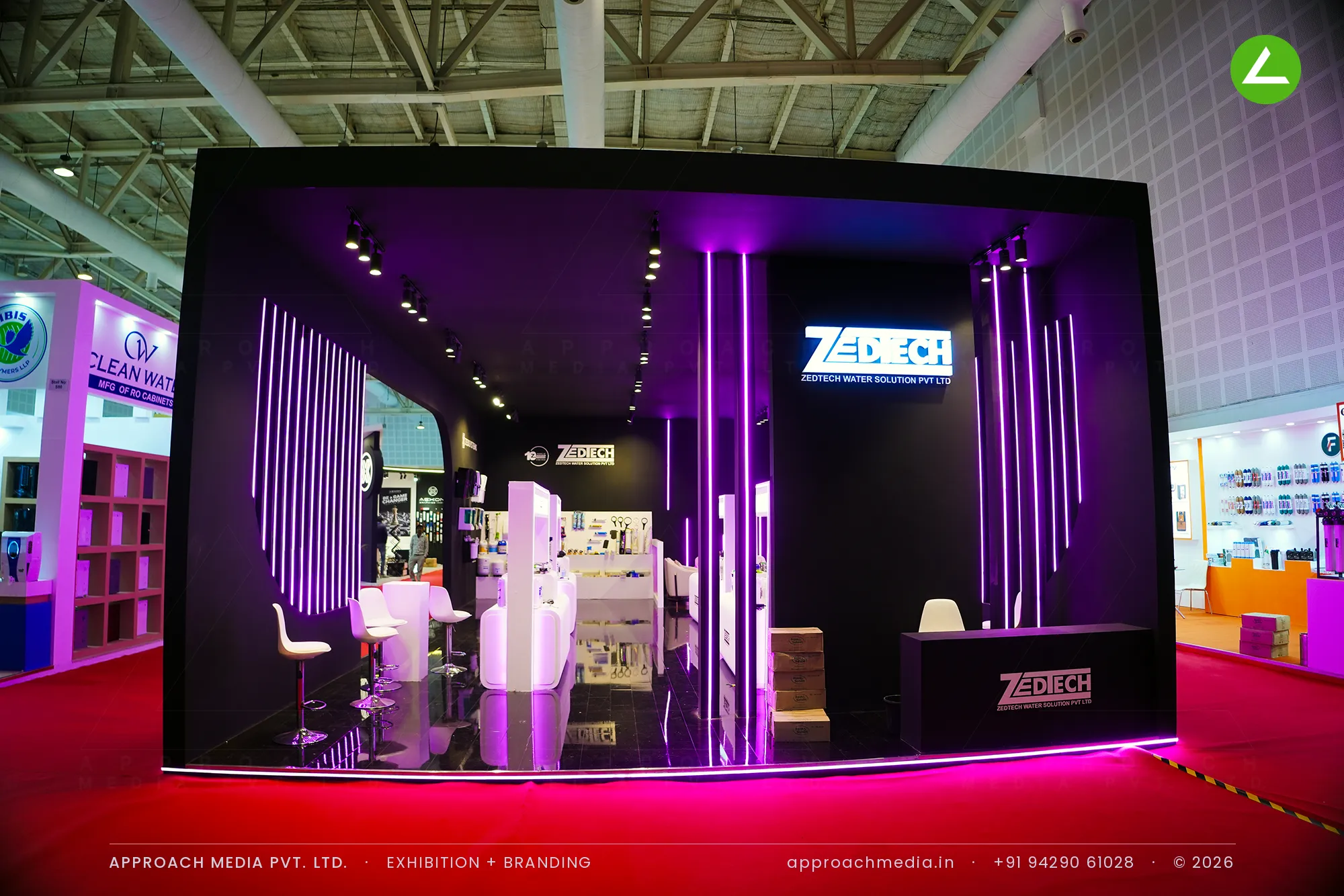 Zedtech exhibition stall design at WAPTAG Water Expo Gandhinagar, matte black frontage with vertical magenta LED light lines