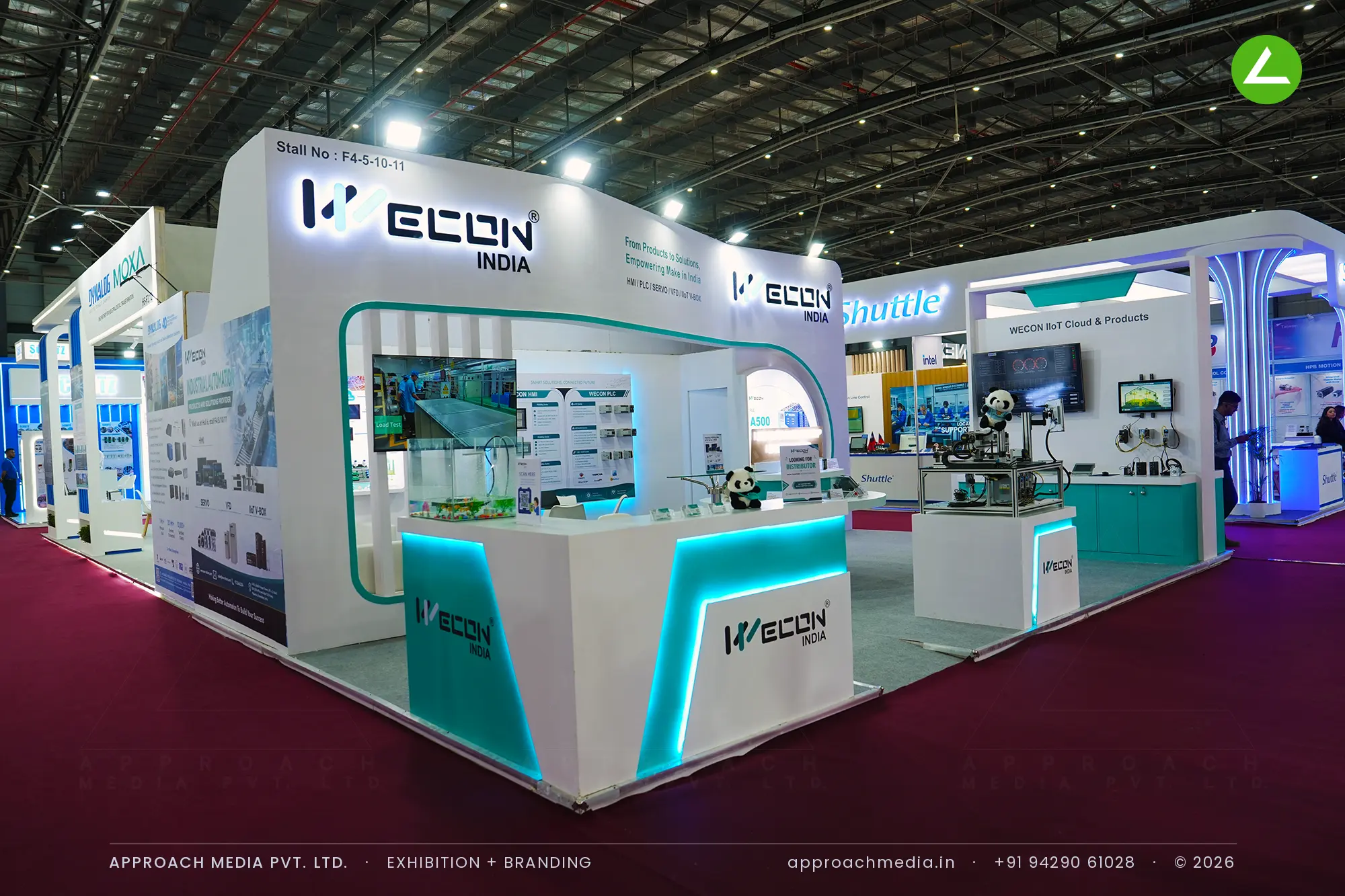 Wecon India teal and white counters below a lit fascia — exhibition stall design at Automation Expo Mumbai