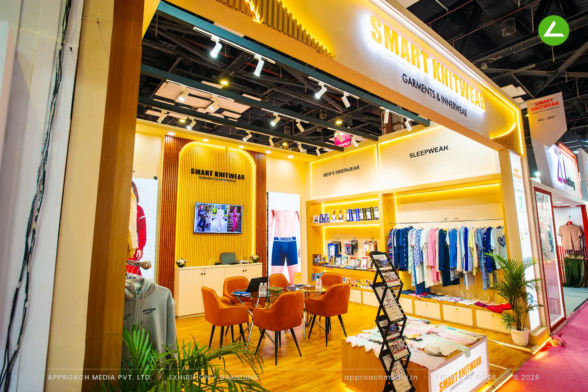 Smart Knitwear lit garment rails and shelf niches — exhibition stall design at Bharat Tex New Delhi
