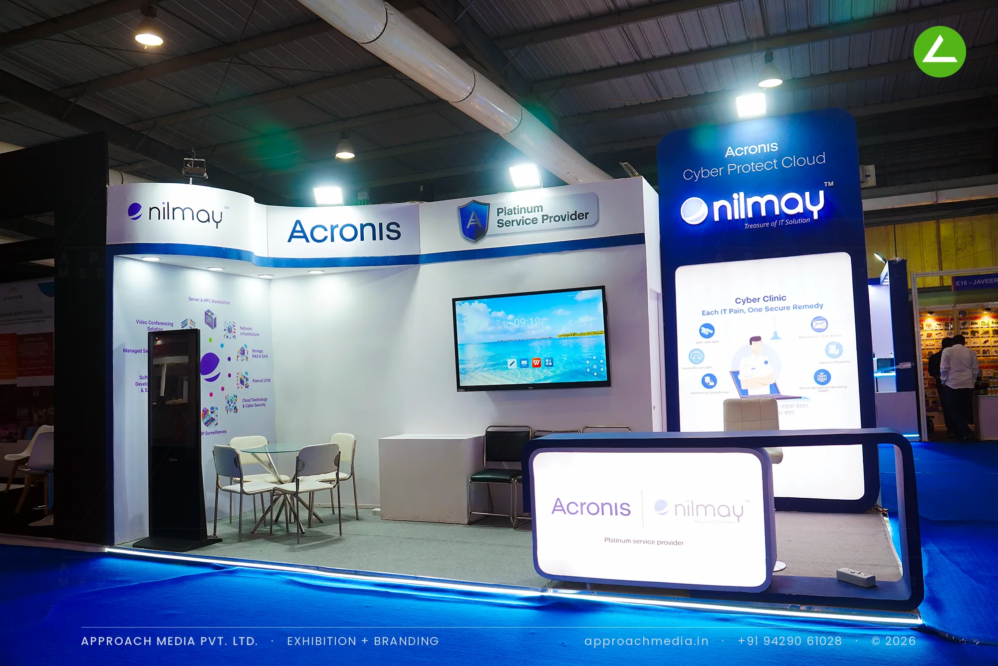 Acronis Nilmay exhibition stall design at FITAG Tech Expo Gandhinagar with backlit navy tower and curved white fascia