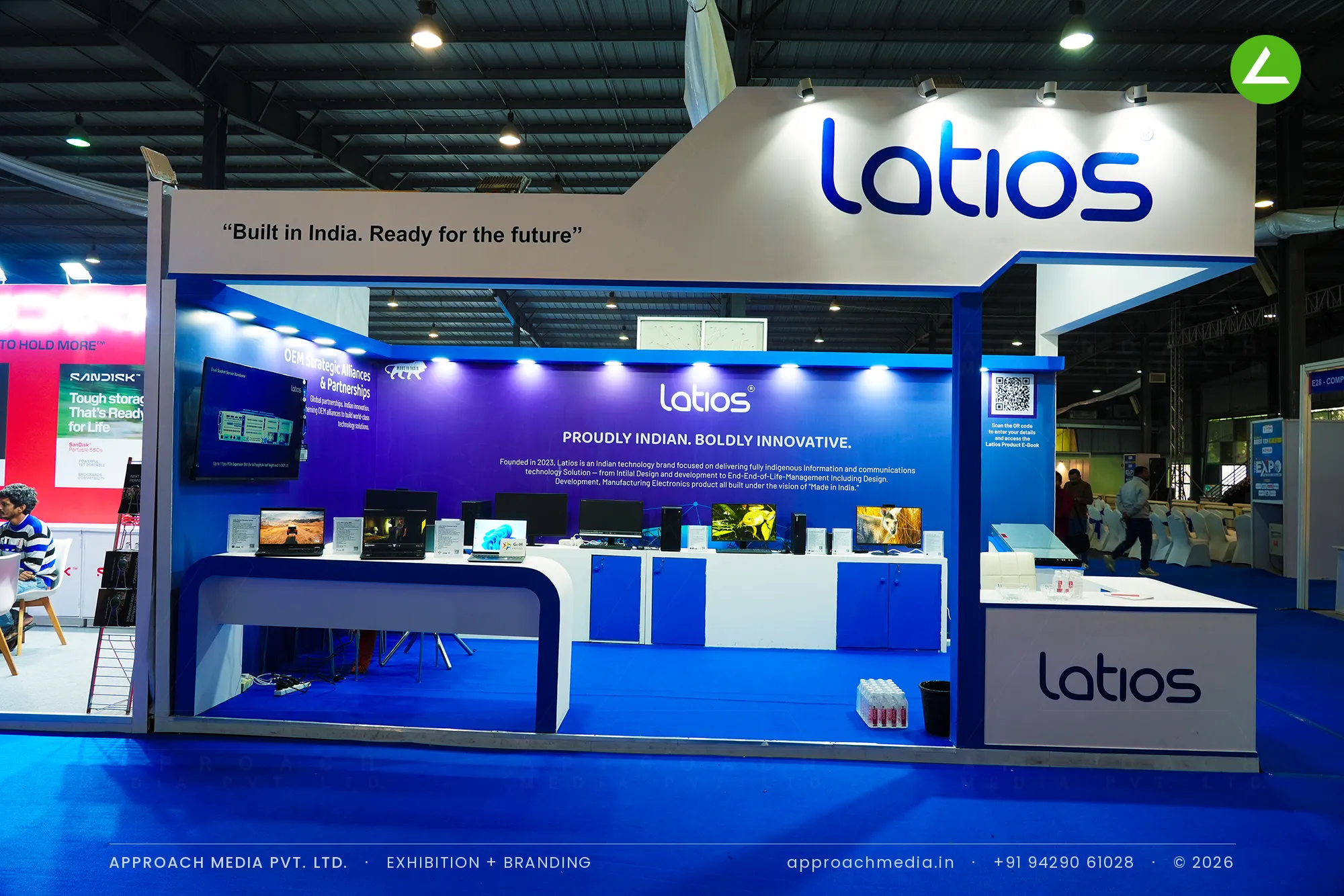 Latios exhibition stall design at FITAG Tech Expo Gandhinagar: raised header over a blue gradient bay — photo 3