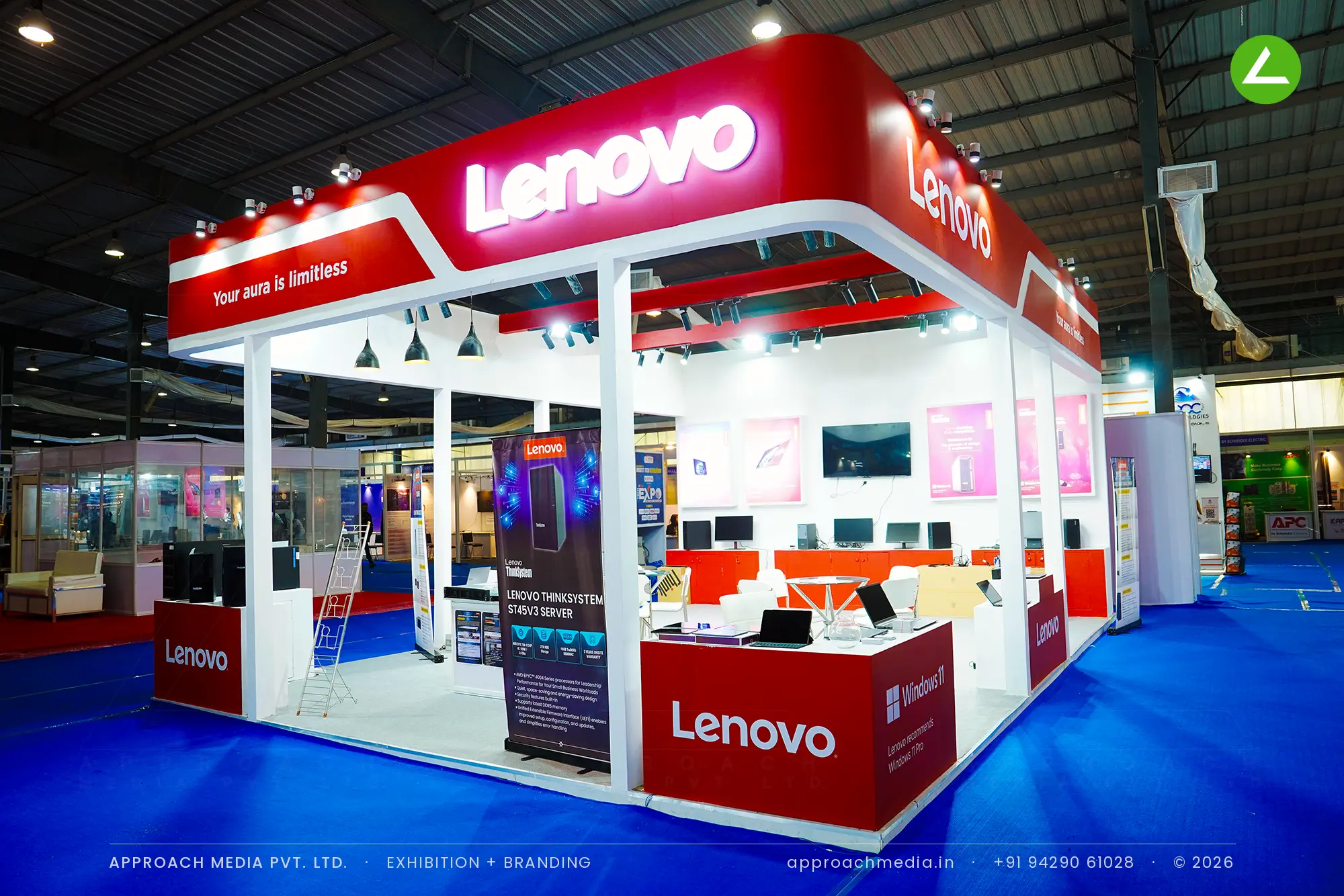 Lenovo exhibition stall design at FITAG Tech Expo Gandhinagar, a red canopy island on white columns with lit logos