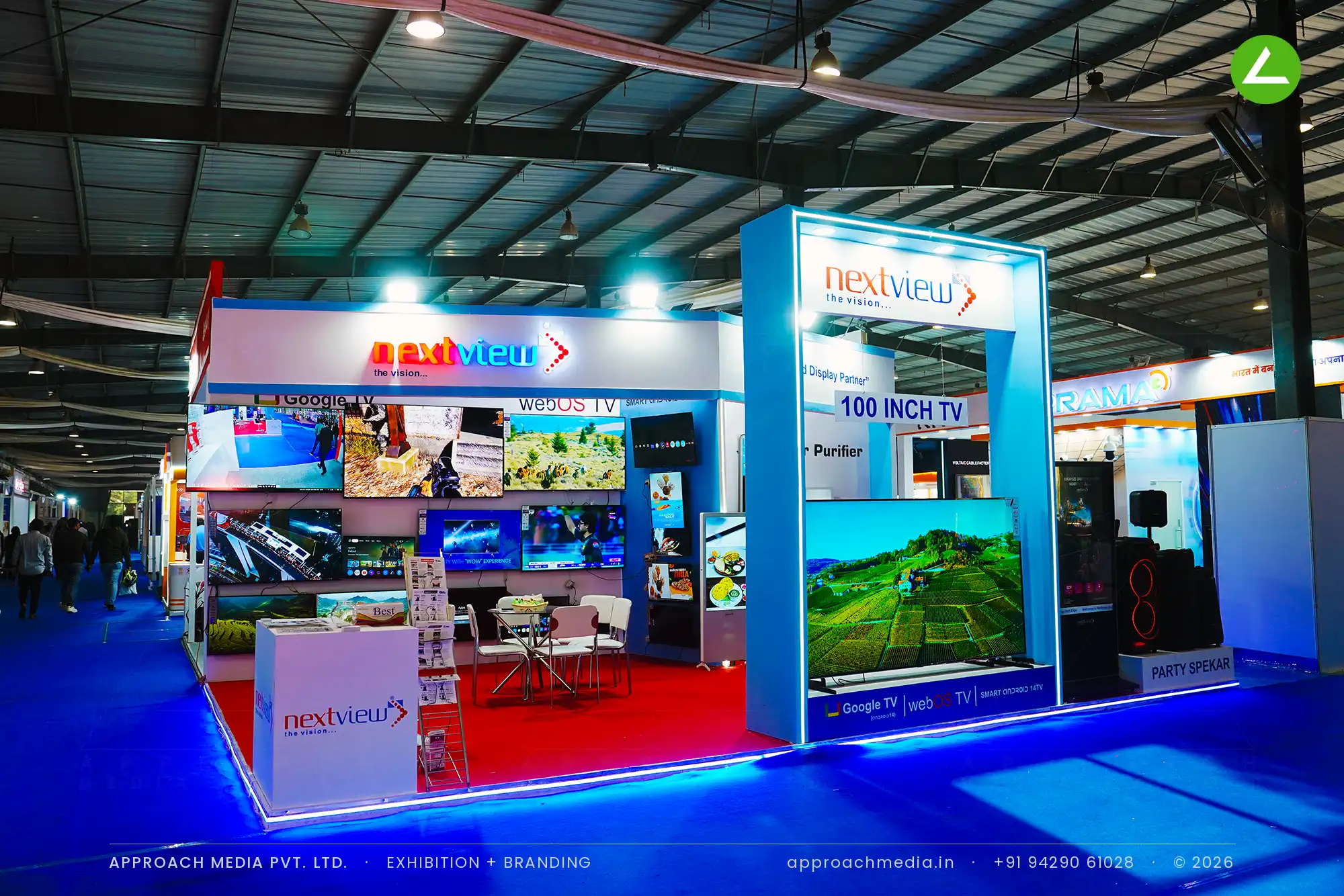 Nextview exhibition stall design at FITAG Tech Expo Gandhinagar with LED-lit portal and a wall of running televisions
