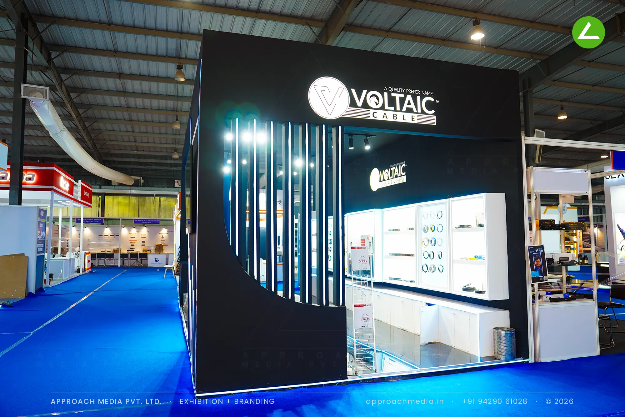 Voltaic Cable exhibition stall design at FITAG Tech Expo Gandhinagar: black walls, lit vitrines — photo 3