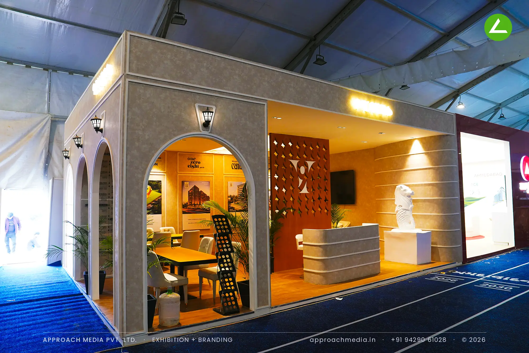 9 Yards exhibition stall design at GIHED Property Show Ahmedabad with arched stone-finish frontage and lantern sconces