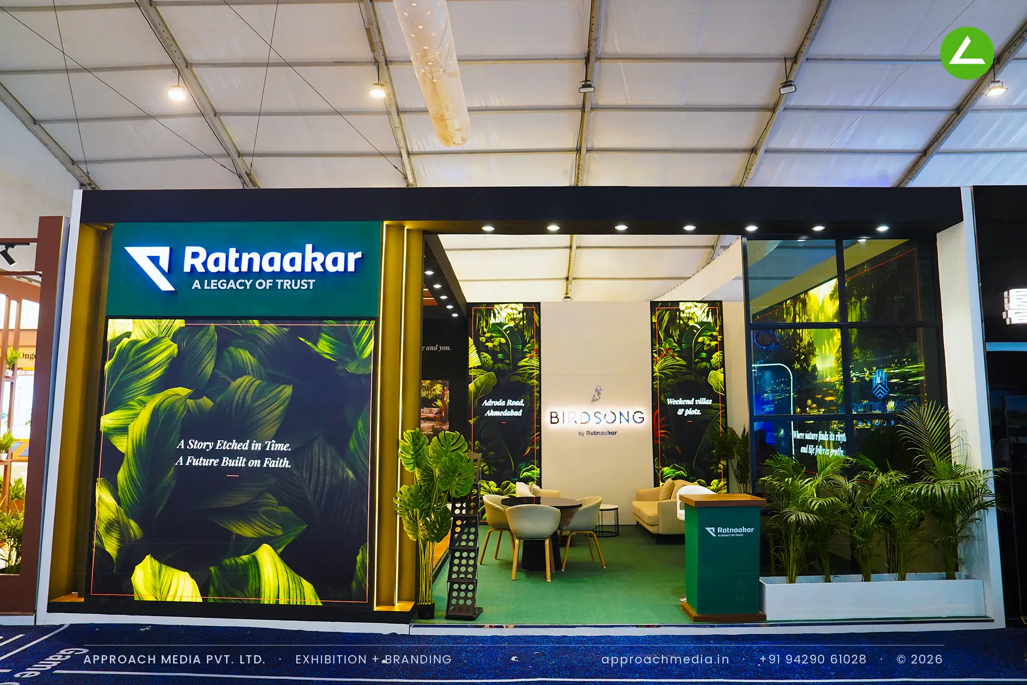 Birdsong by Ratnaakar exhibition stall design at GIHED Property Show Ahmedabad with foliage graphics and live palms