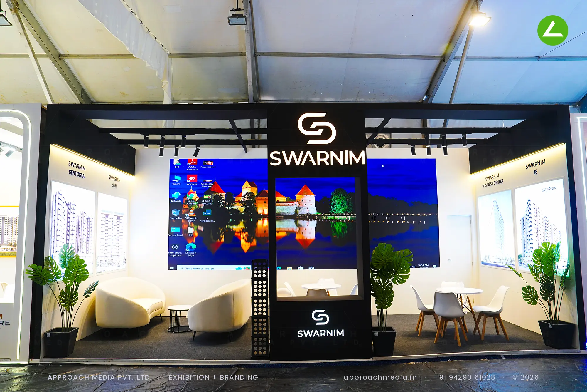 Swarnim exhibition stall design at GIHED Property Show Ahmedabad with black portal fascia, LED screens and lounge seating