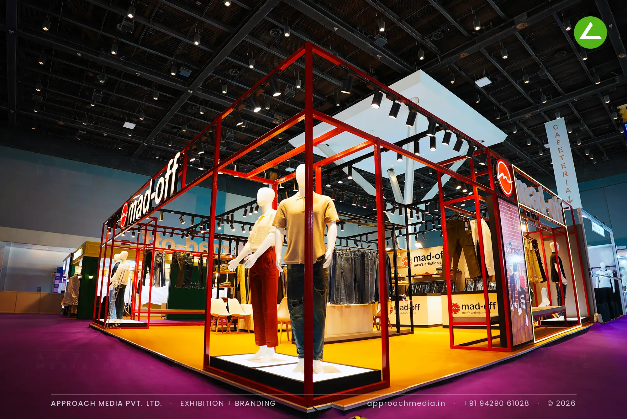 Open red steel frame over denim rails and mannequins — exhibition stall design at IGTF Man Expo Mumbai for Madoff