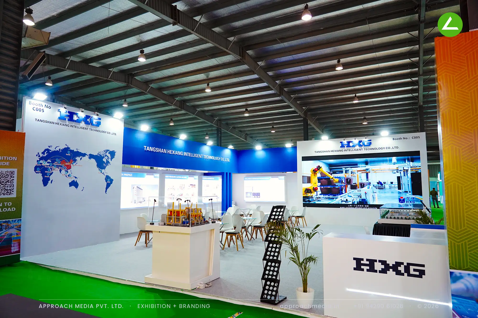 HXG exhibition stall design at Indian Ceramics Asia Gandhinagar with blue fascia band, LED wall and machine scale models