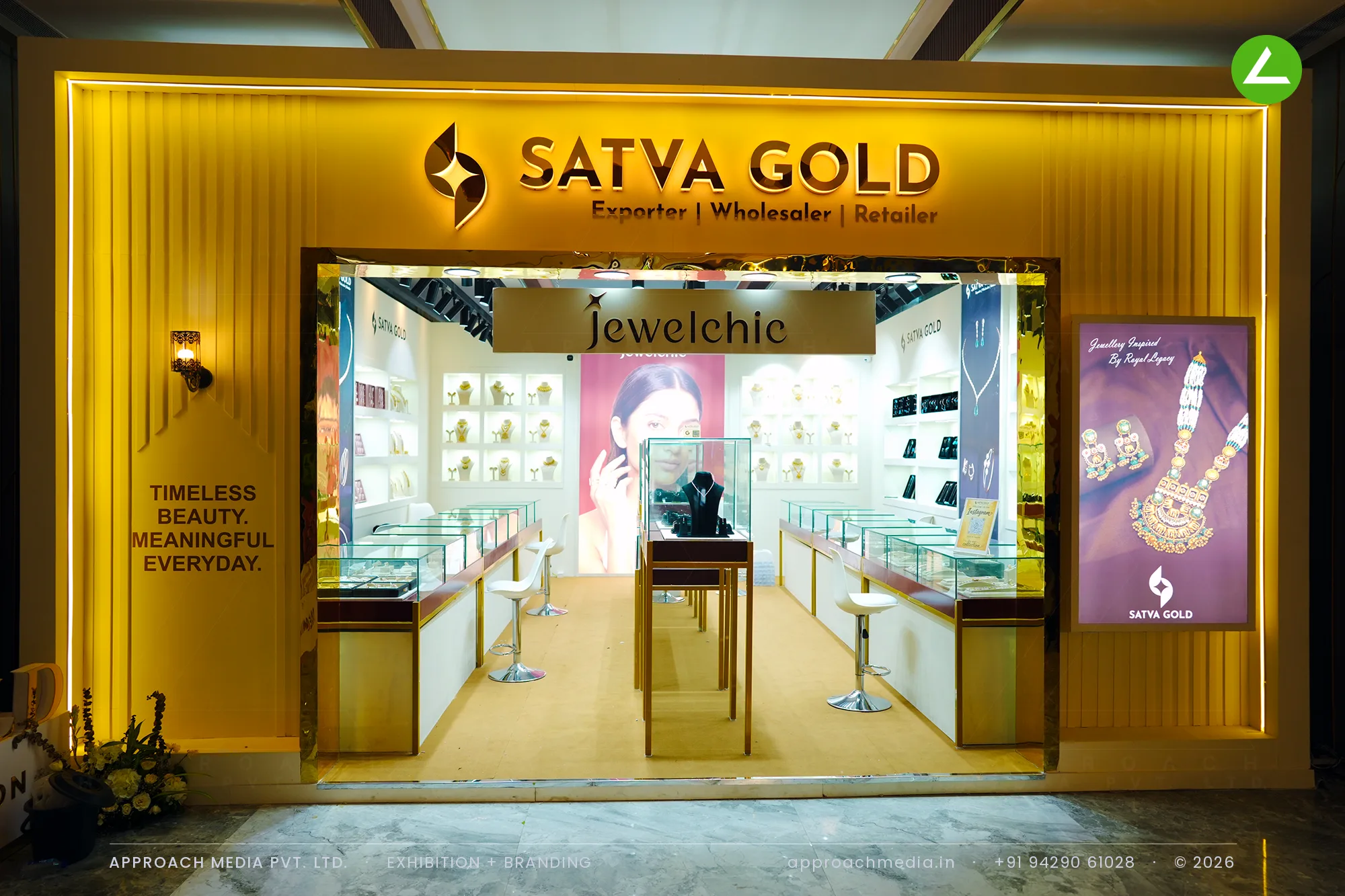 Gold fluted frontage with halo-lit lettering — exhibition stall design at Jewellery World Expo Ahmedabad for Satvagold