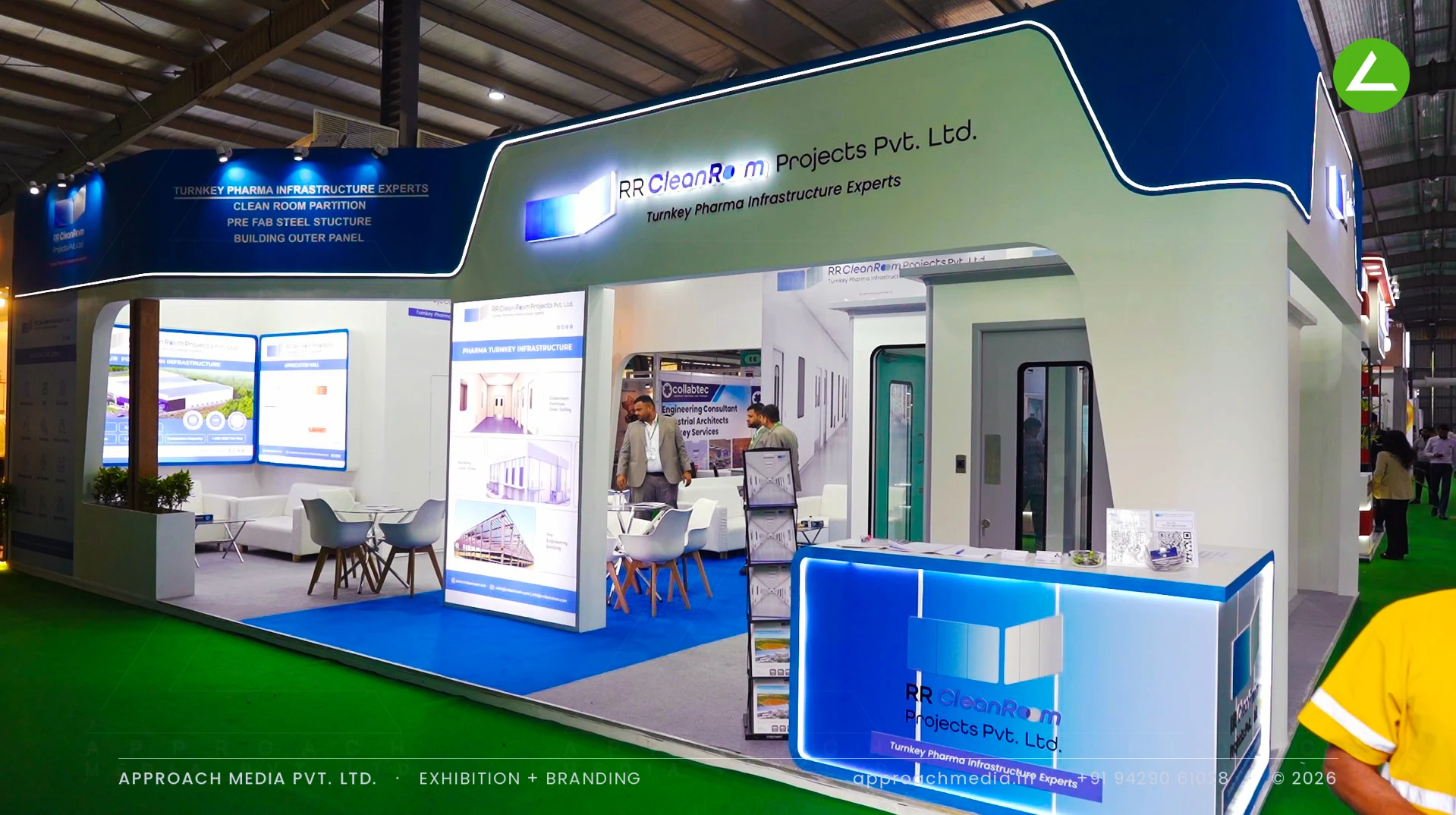 RR Clean Room exhibition stall design at Pharmatech Expo Gandhinagar, white cleanroom build under a backlit navy fascia