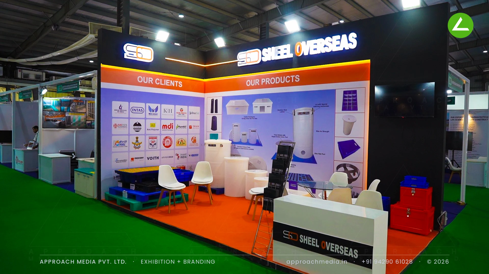 Sheel Oversies exhibition stall design at Pharmatech Expo Gandhinagar with a black header, orange floor and tank display