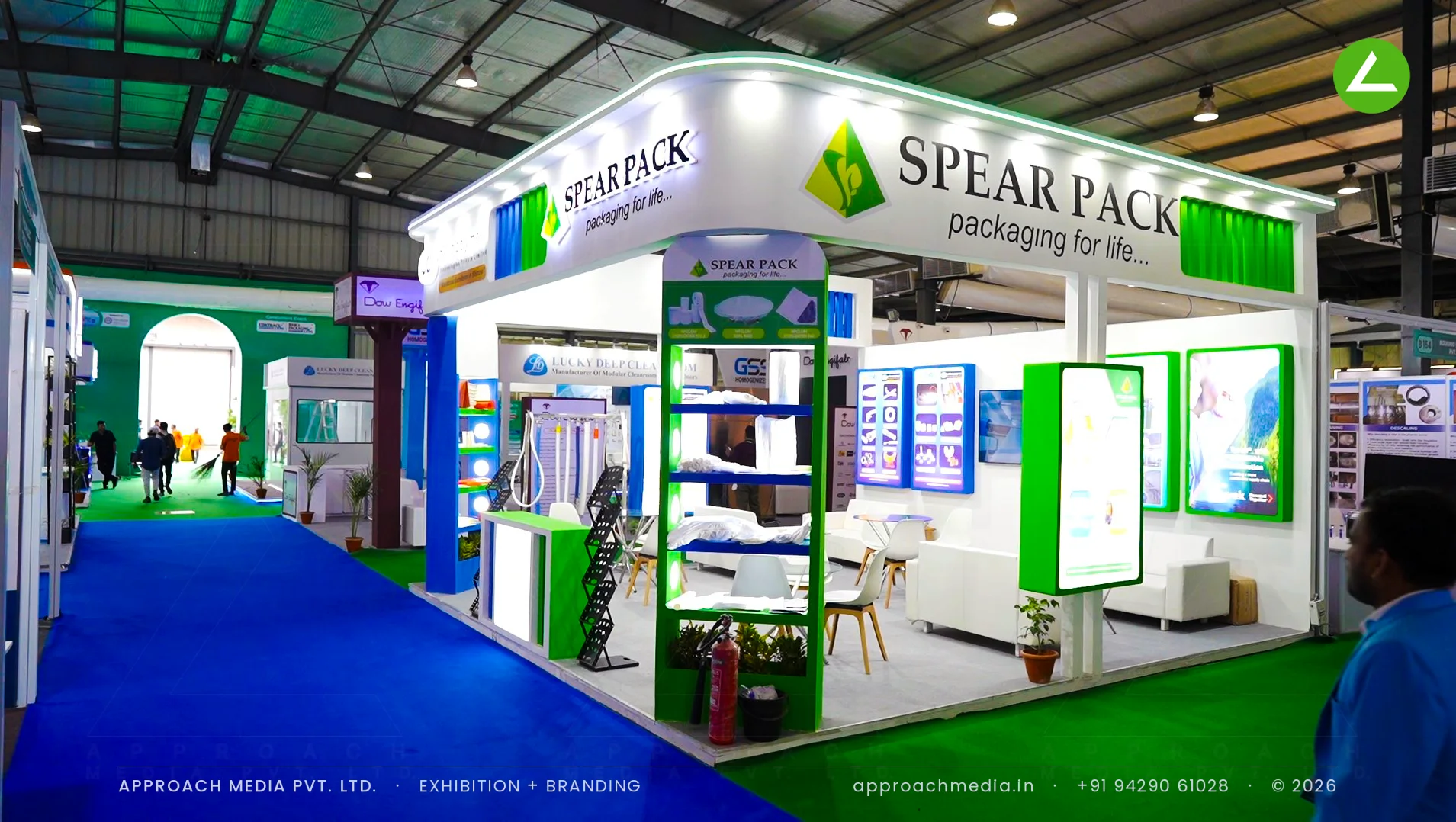 Superpack exhibition stall design at Pharmatech Expo Gandhinagar with backlit green panels and porthole display shelves