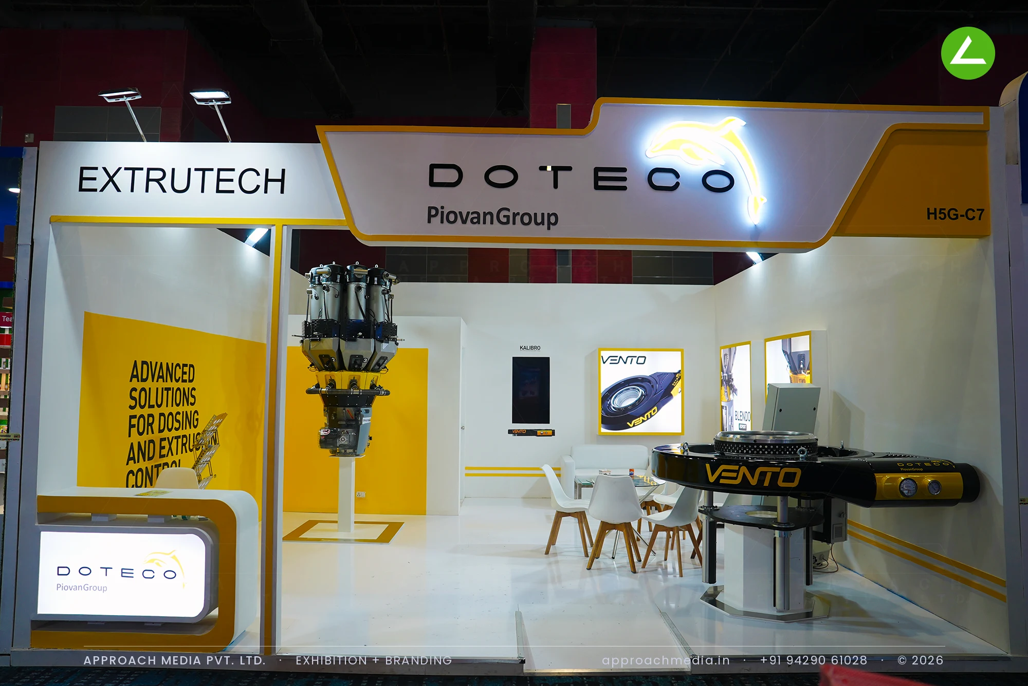 Doteco Piovan Group white and yellow exhibition stall design at PlastIndia New Delhi with dosing machinery on display