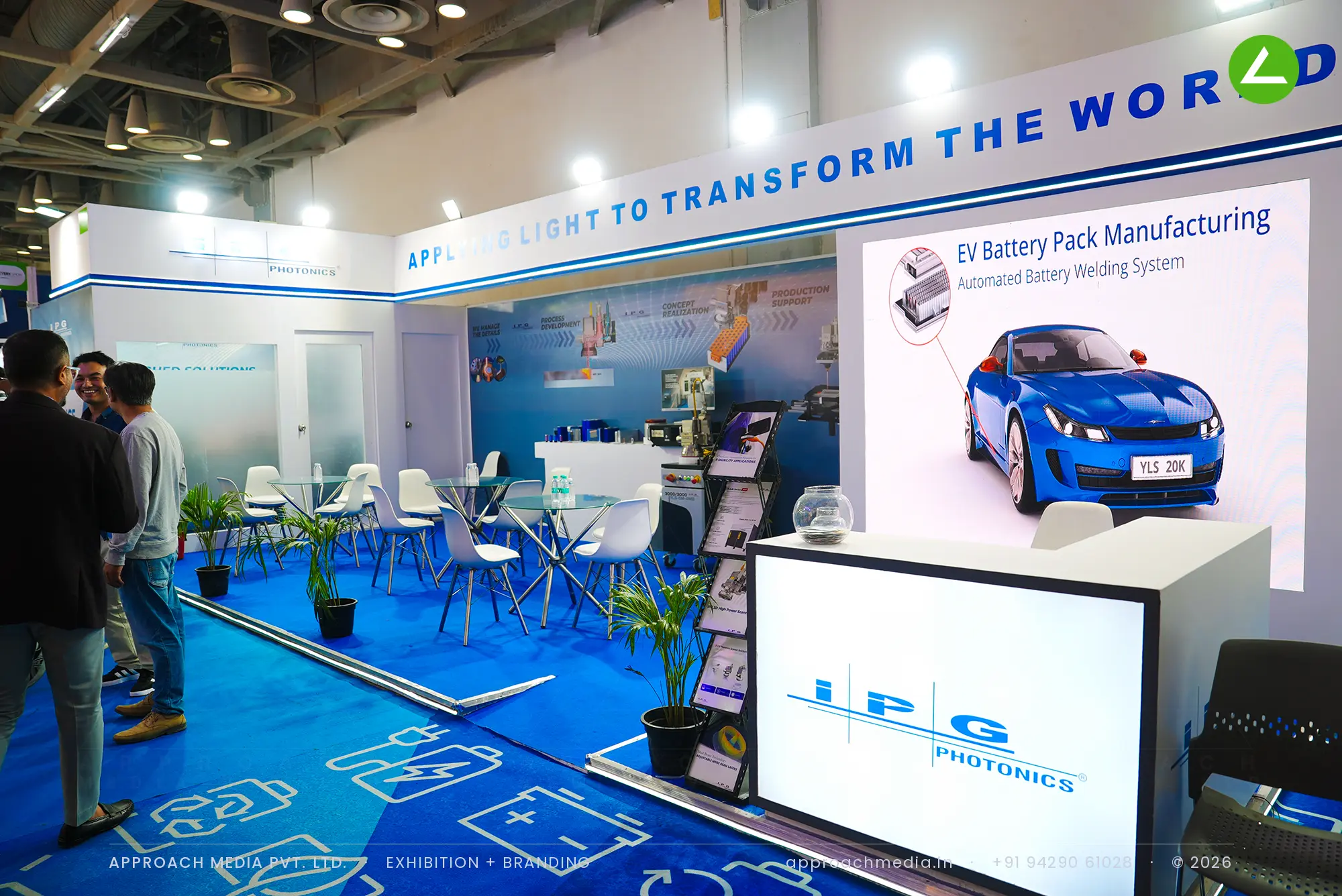 Exhibition stall design at REI Greater Noida: IPG Photonics blue stand with a printed EV battery floor