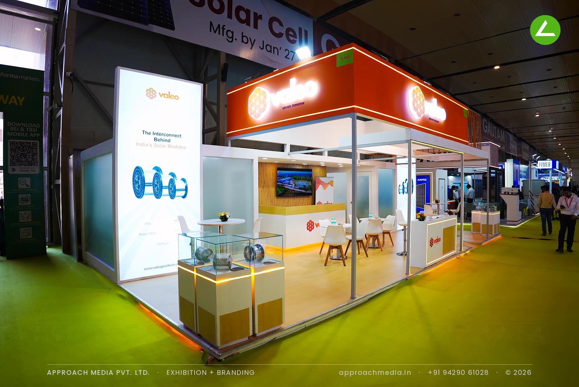 Exhibition stall design at REI Greater Noida: Valeo stand with an orange fascia box and glass vitrines